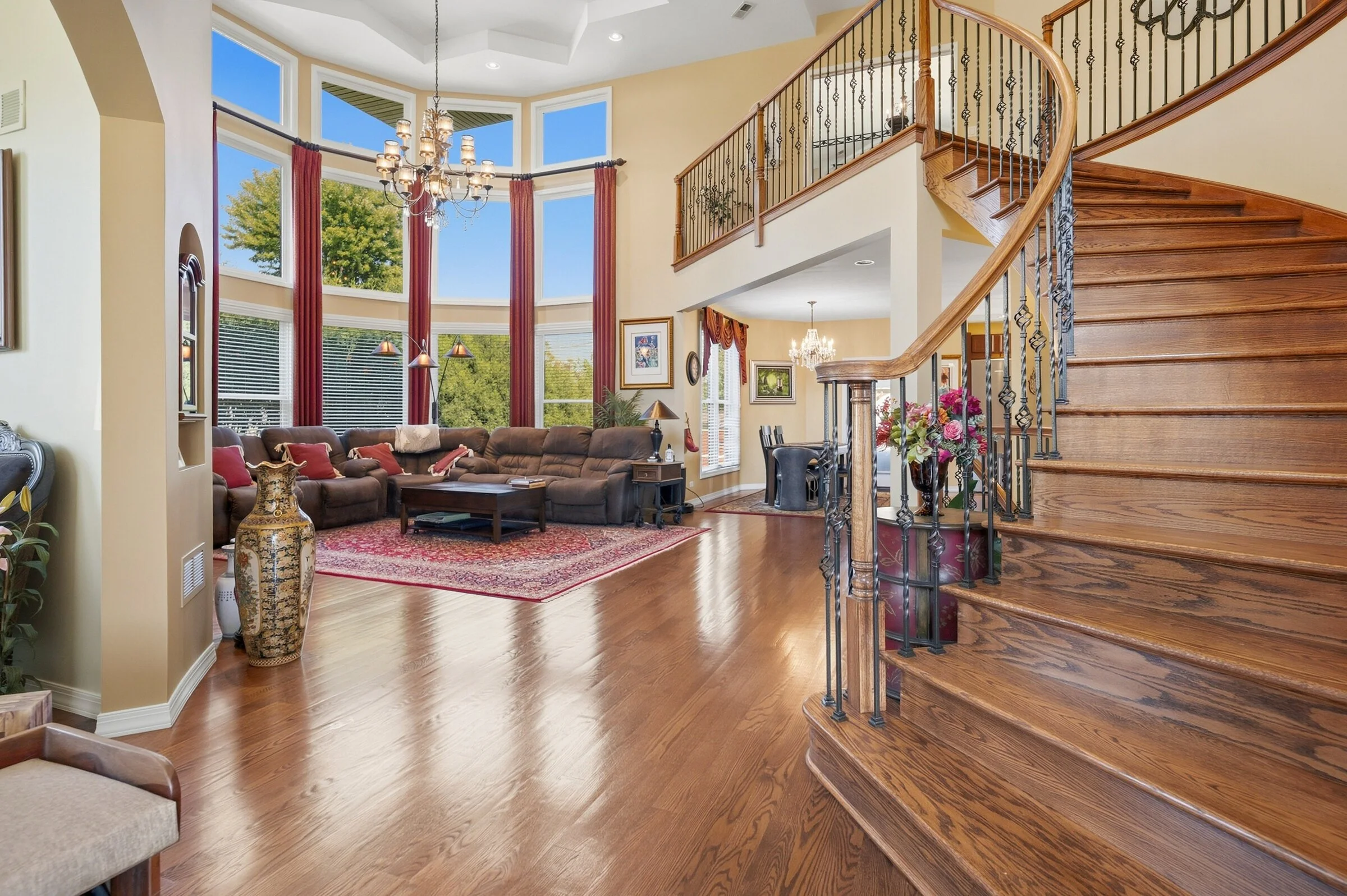 lincolnshire-curved-staircase-wrought-iron-balusters-open-to-family-room.jpg