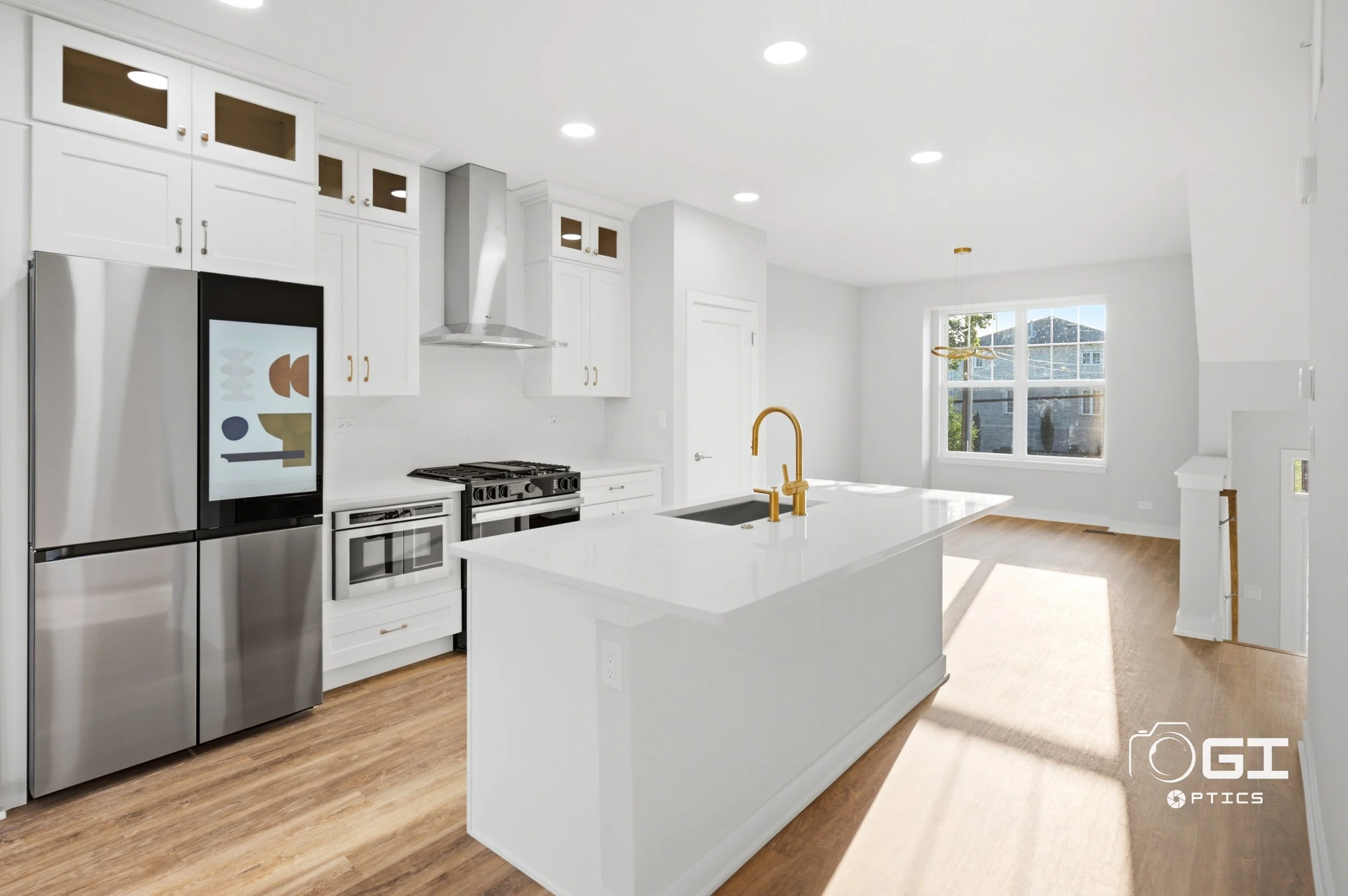 des-plaines-townhome-kitchen-white-cabinets-quartz-island-gold-faucet.jpg