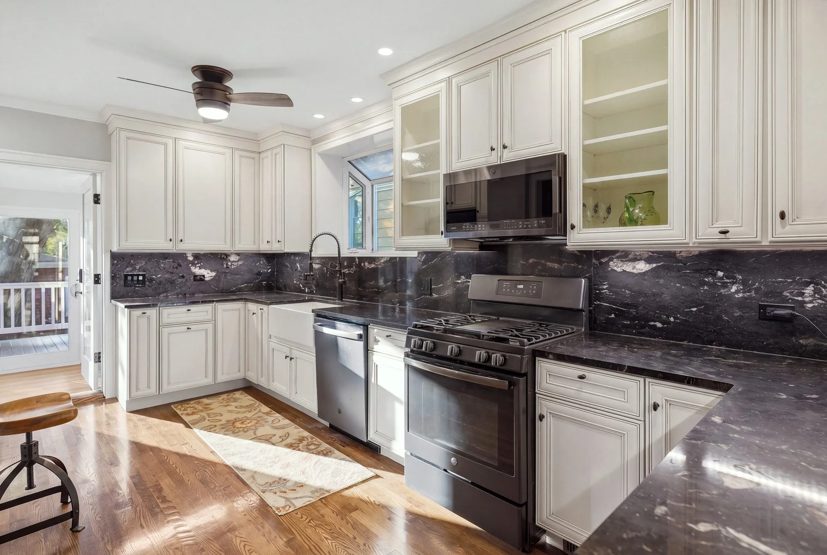 Remodeled Berwyn bungalow kitchen with granite counters and white cabinets.jpg