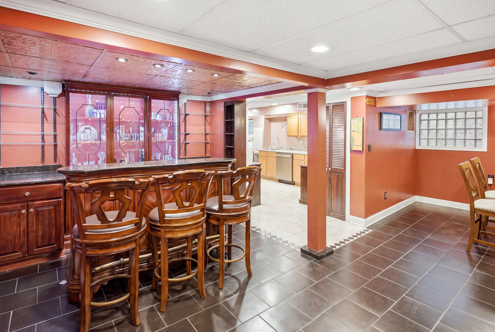 Finished basement bar with wood stools in a Berwyn bungalow.jpg
