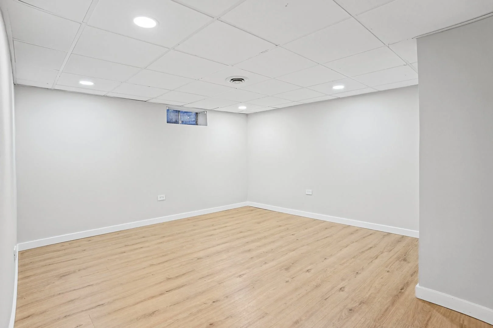 Bright empty lower level room with recessed lighting.jpg
