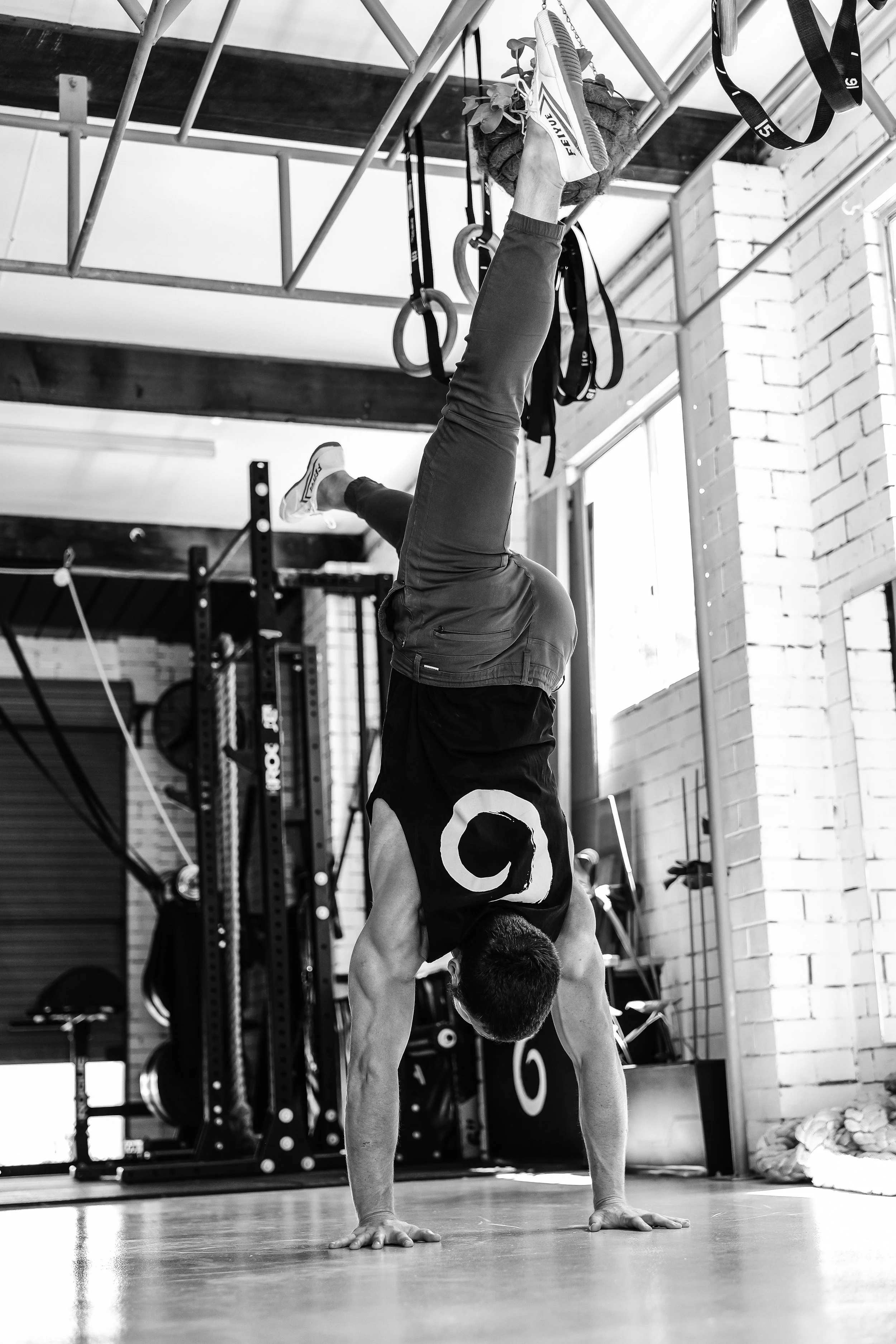 Handstand practice in a gym environment, developing balance, strength, and body awareness.