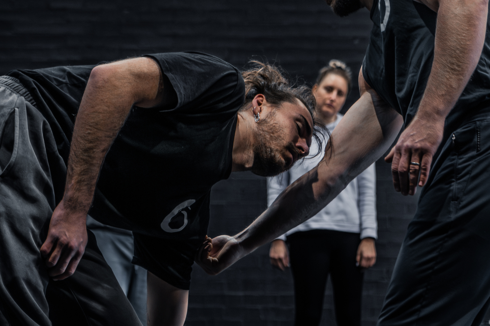 Partner-based ground movement practice, exploring strength, coordination, and body awareness.