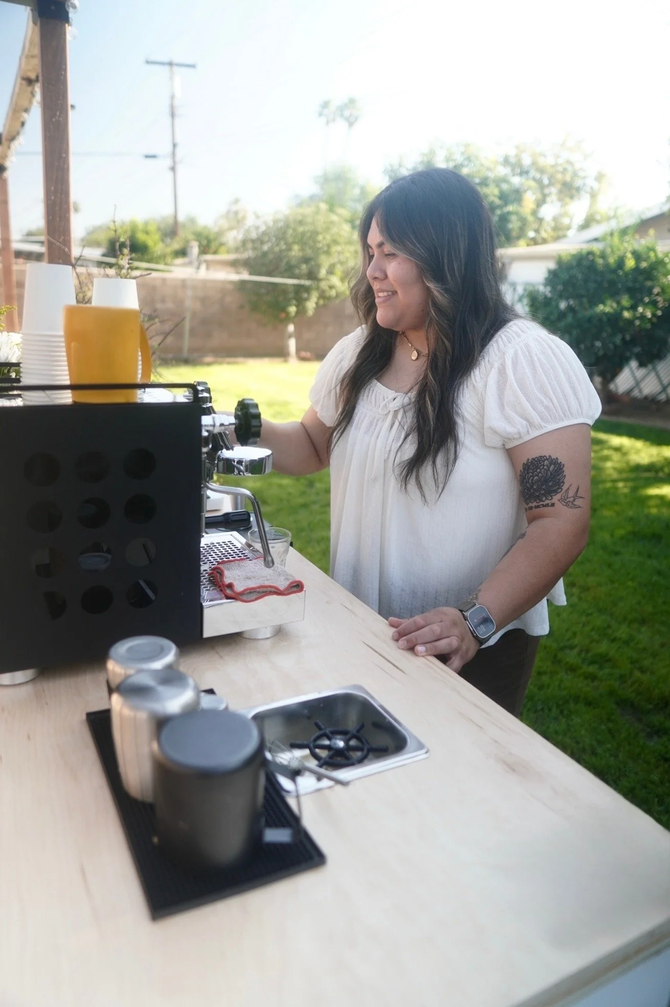 barista serving lattes to guest