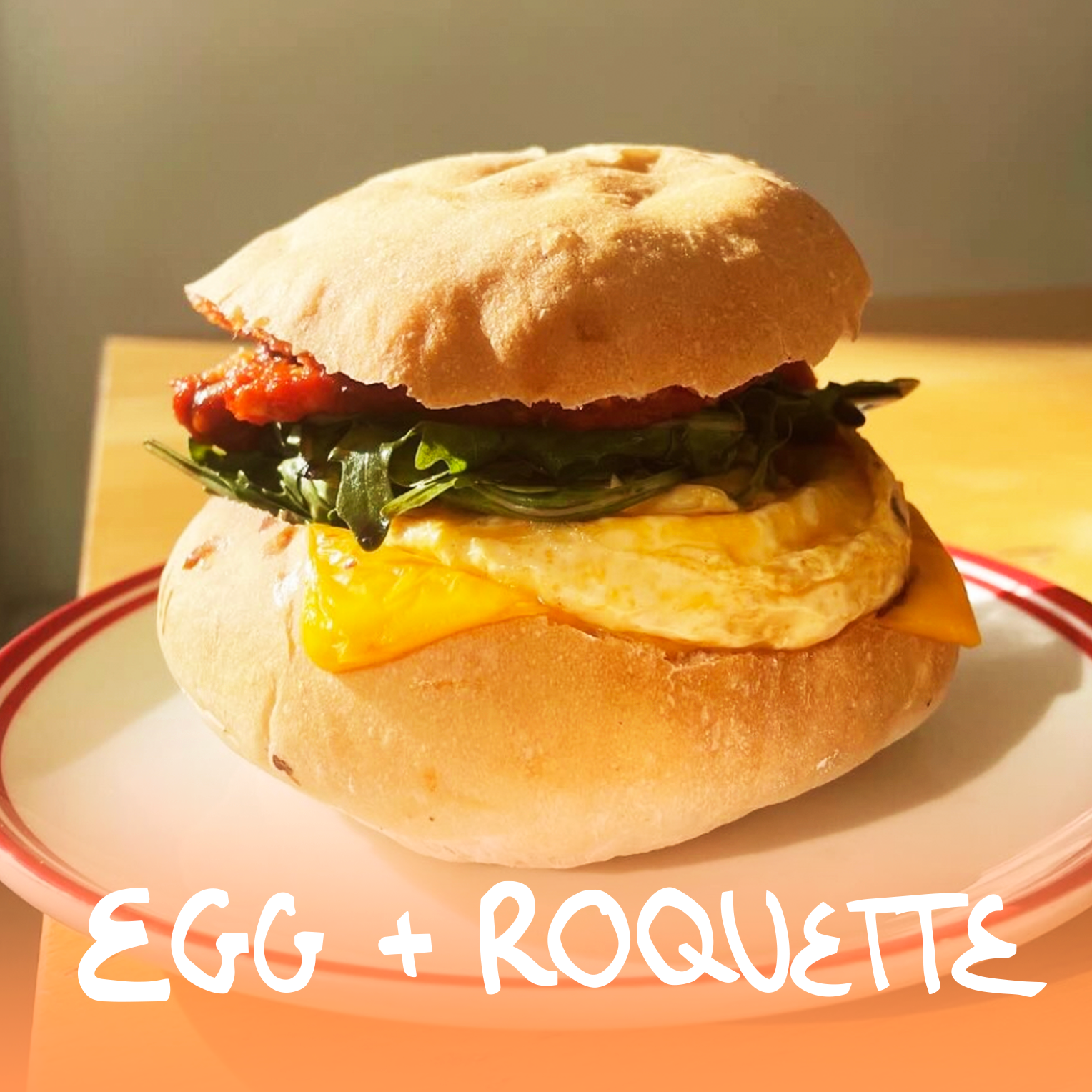 Folded eggs with Rocket (roquette if you’re fancy), Balsamic Glaze, American Cheddar & Relish on Panini Roll