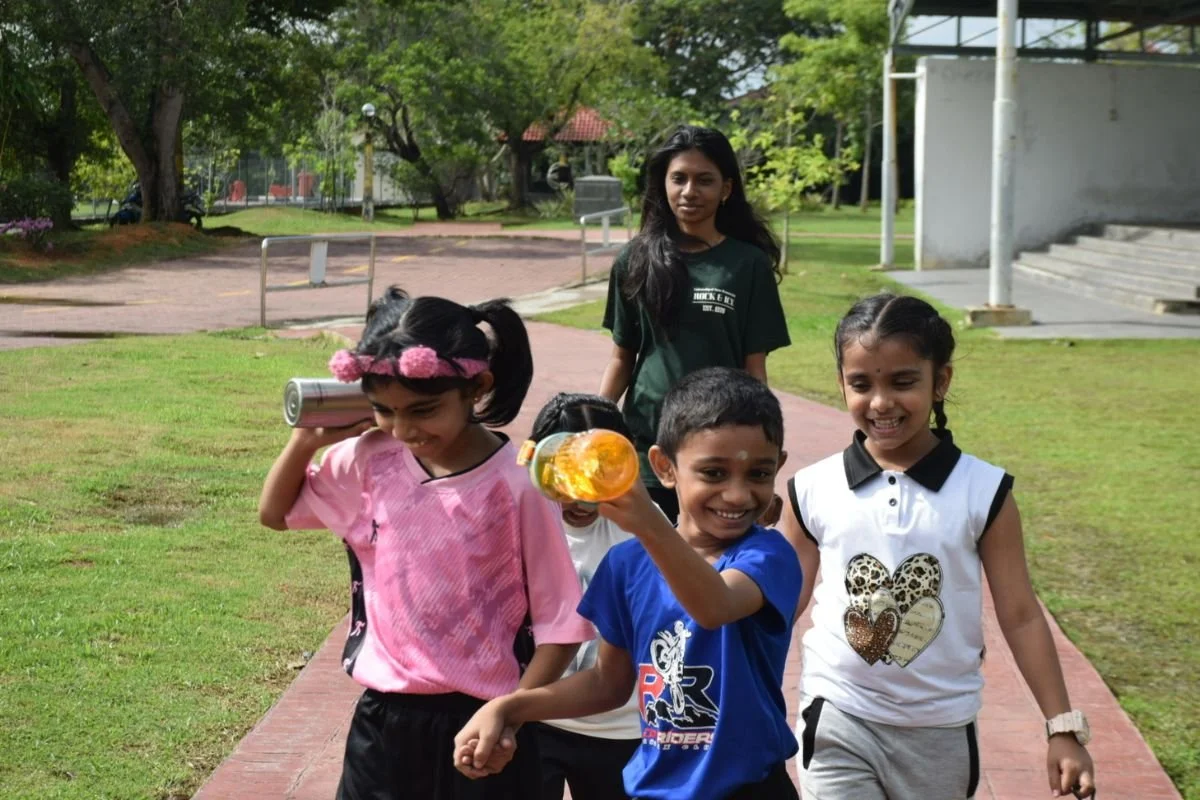 Indian children walking happily during an outdoor Mandarin class in Banting