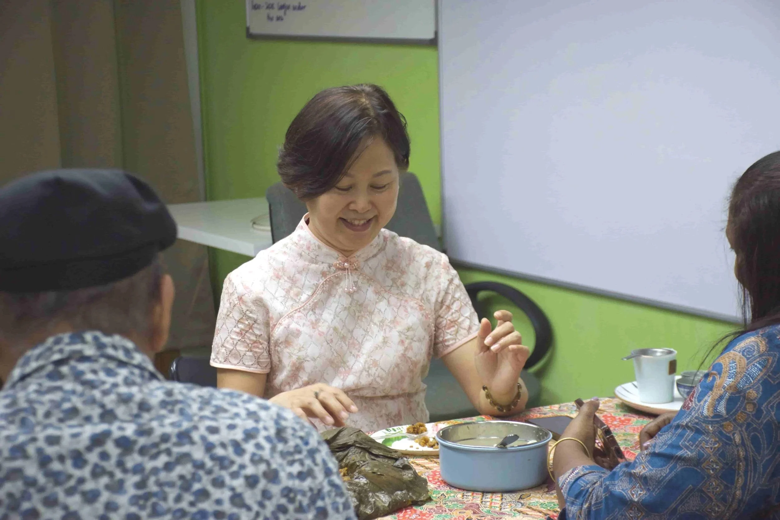 Mandarin language teacher chatting with students in a classroom in Bandar Sri Damansara, Kuala Lumpur