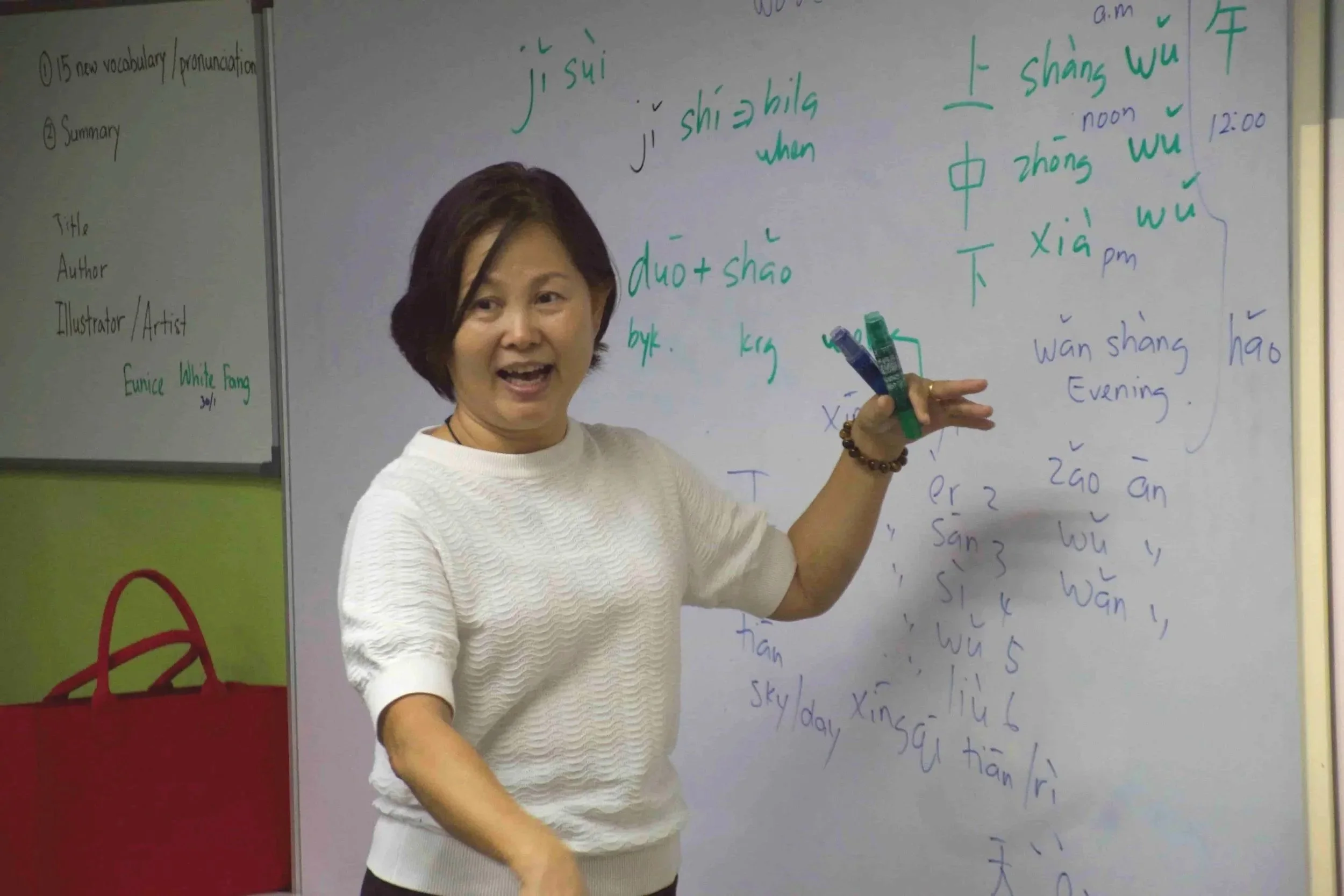 Mandarin language teacher explain Mandarin pronunciation  in a classroom in Banting