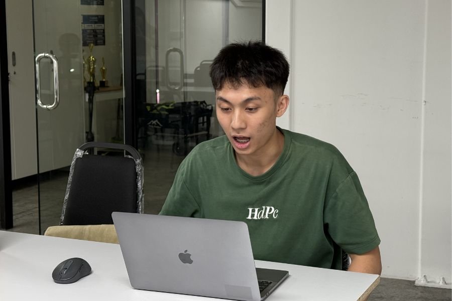 Student attending an online Mandarin class on a laptop at a classroom in Malaysia