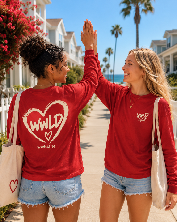 Two friends high-fiving in red WWLD Signature Crewnecks
