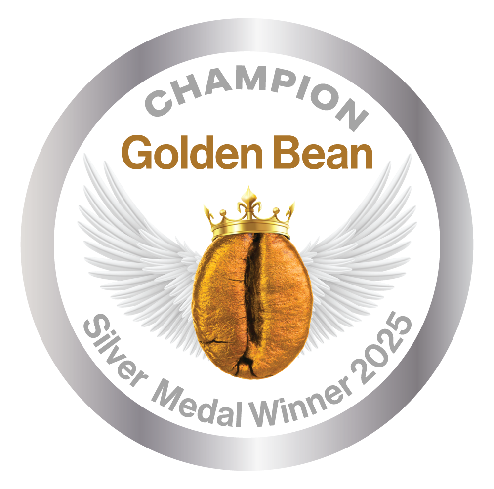 A medal with a golden bean with a crown and angel wings, inscribed with 'CHAMPION Golden Bean Silver Medal Winner 2025'.