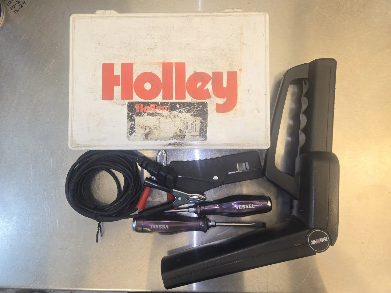 tools and parts to tune carburetors and distributors.
