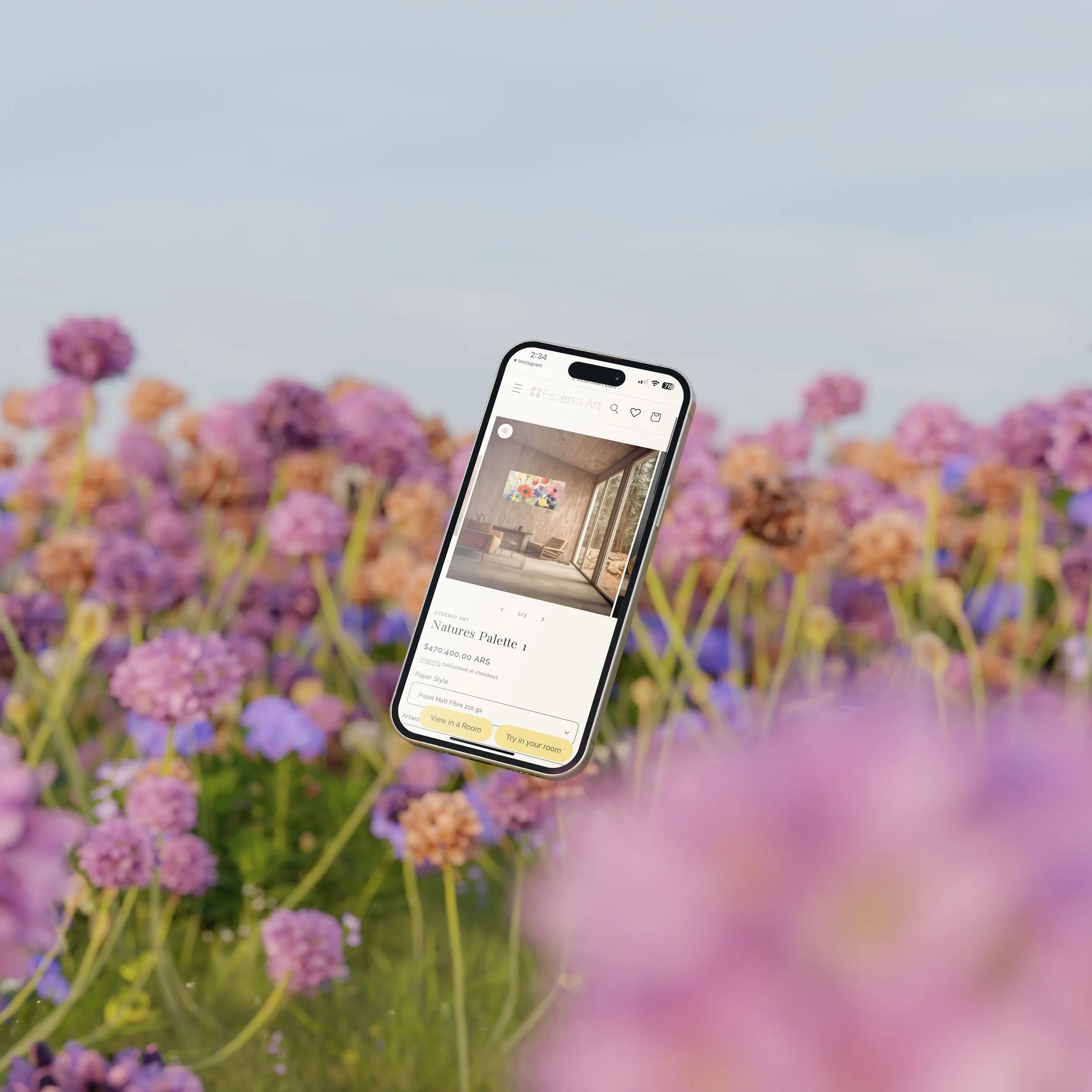 A smartphone floating above a field of purple and pink flowers, displaying an interior design app with a room image and artistic painting.