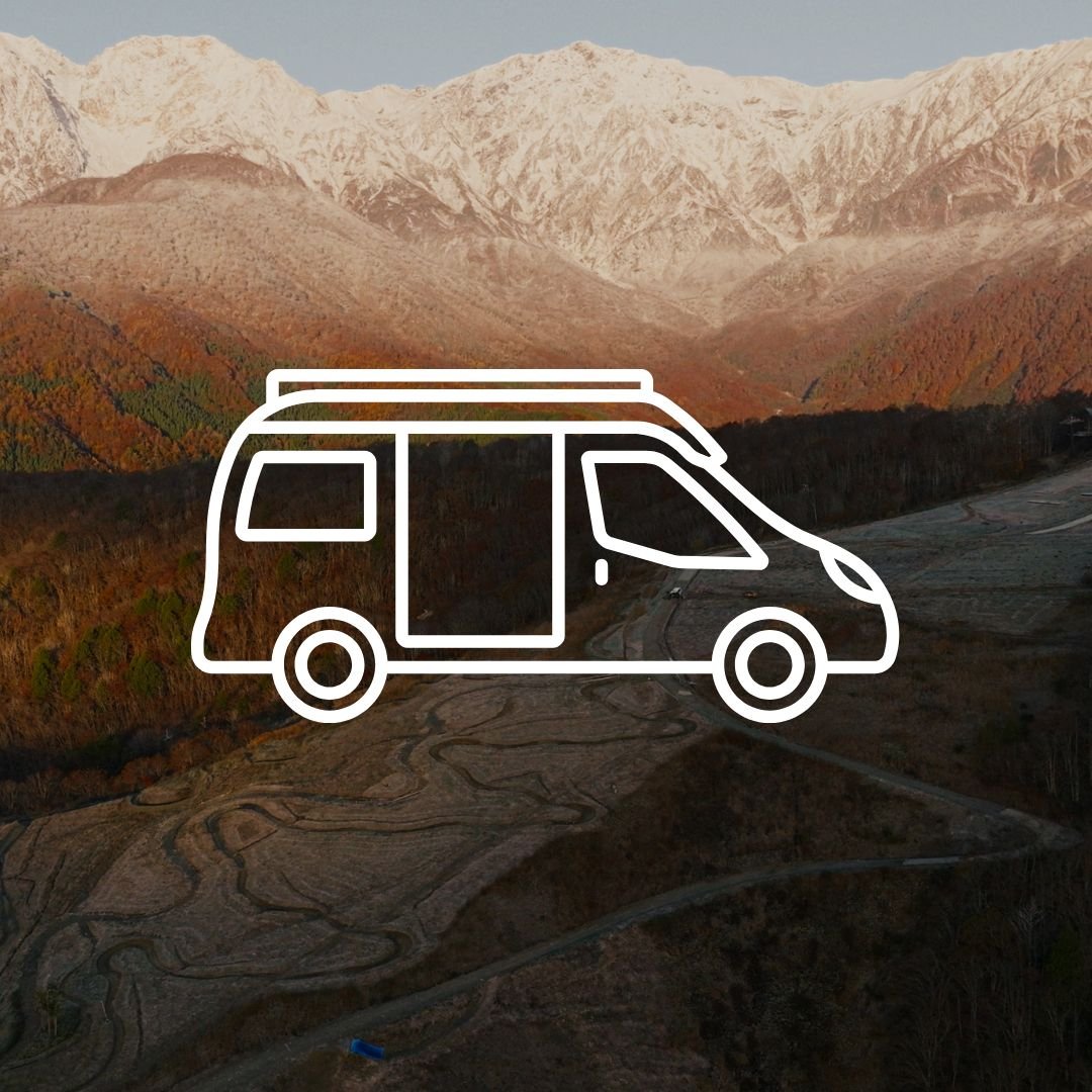 Campervan icon over scenic mountain landscape in Japan, representing road trip travel