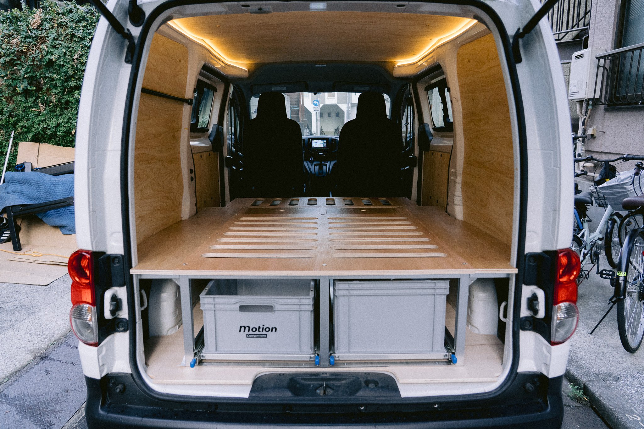 Campervan interior with wooden floor and storage compartments