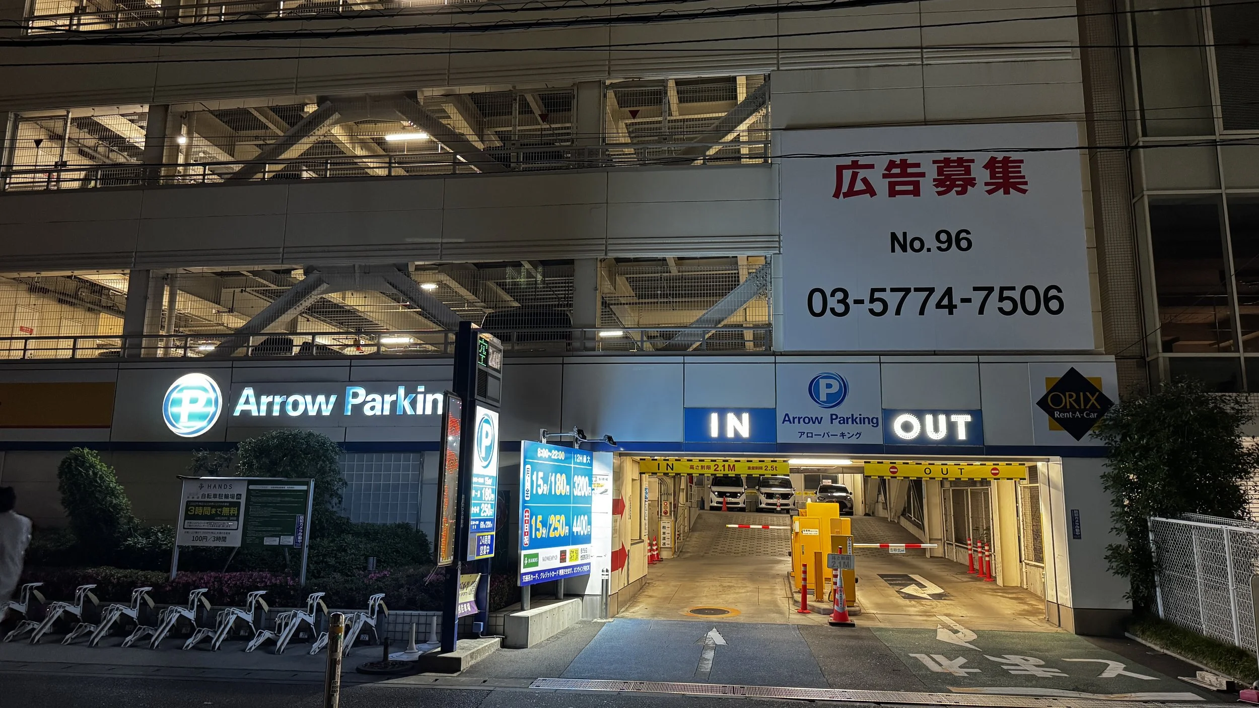 Multi-story coin parking lot Tokyo with campervan parked overnight