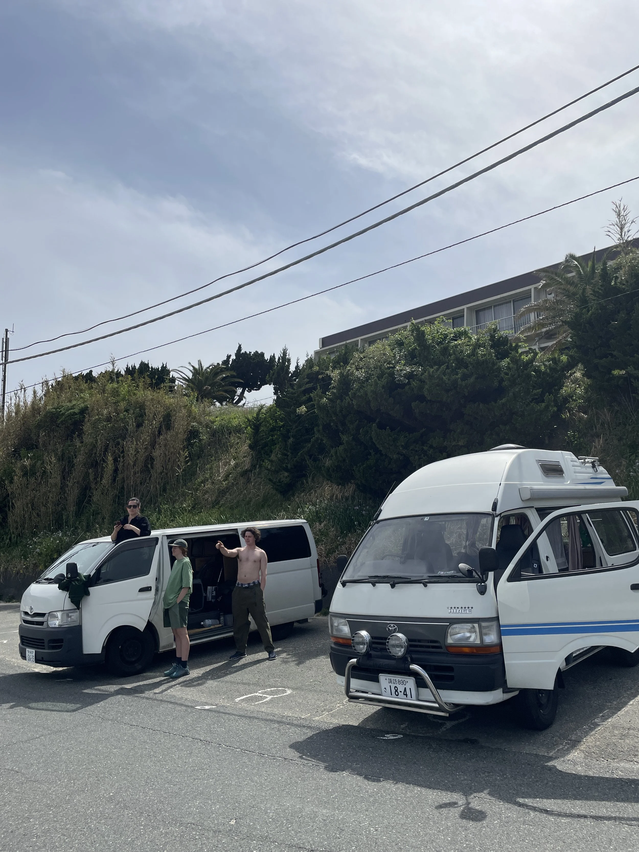 British traveller couple beside a campervan in Shimoda, Izu, Japan