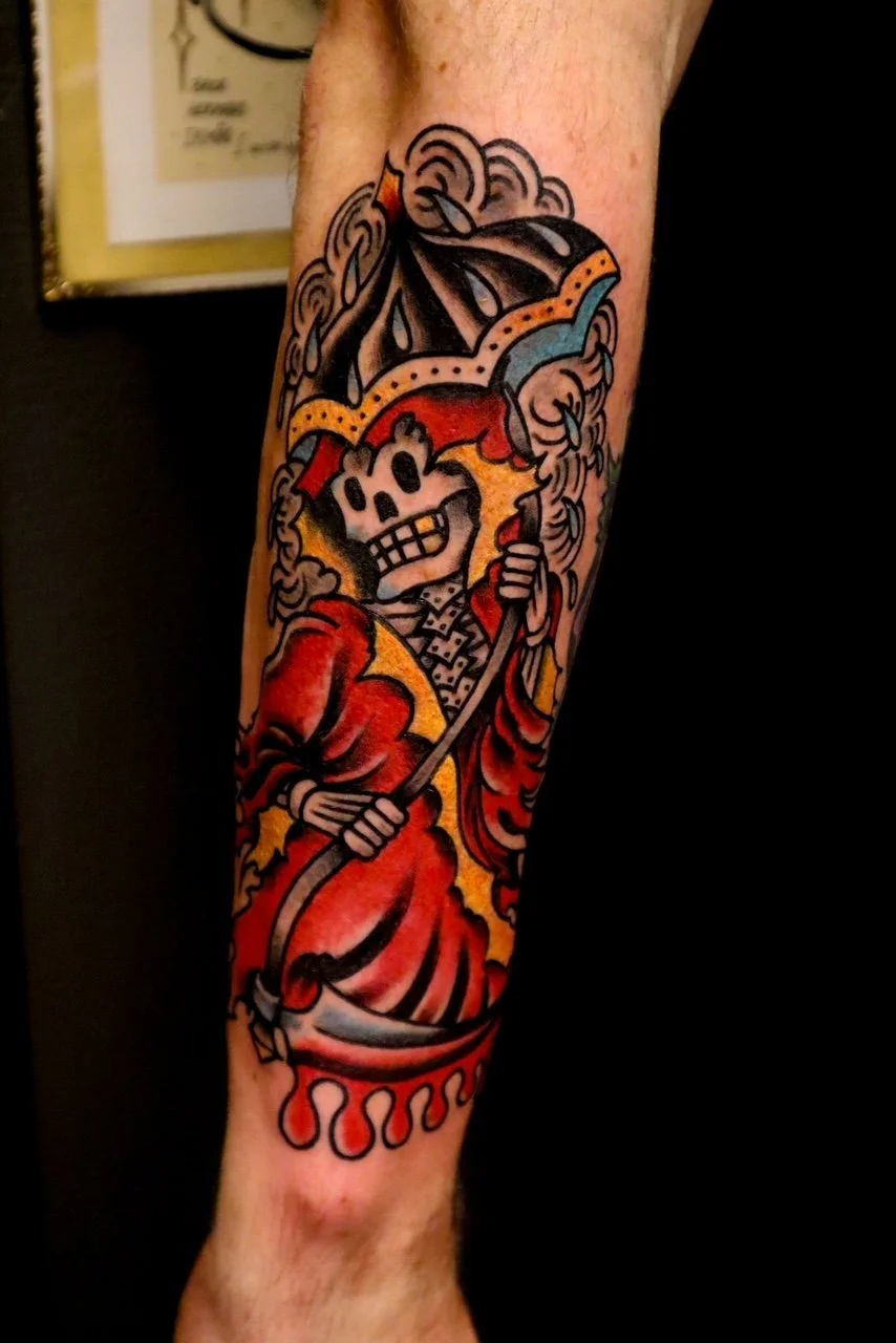 Tattoo of a skeleton in a red robe holding an umbrella, surrounded by clouds and flames.