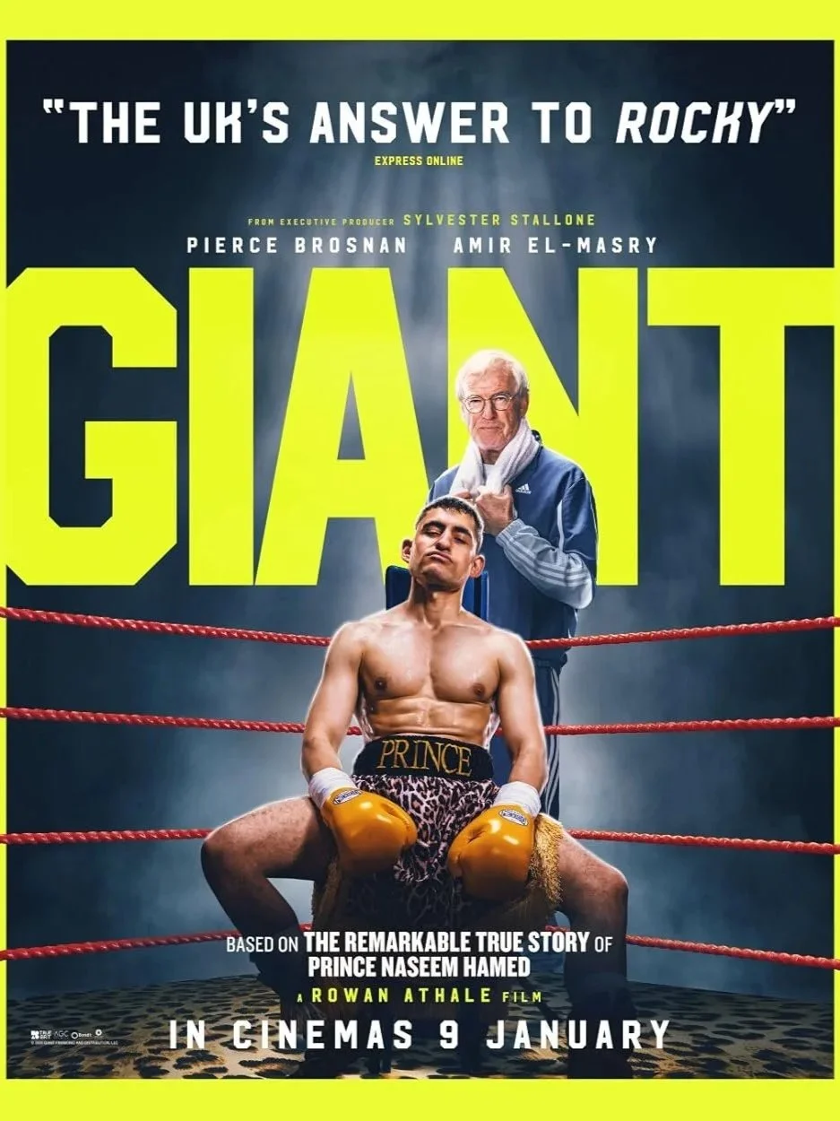 Movie poster titled "GIANT" with a boxer sitting in a boxing ring, wearing leopard print shorts labeled "PRINCE" and boxing gloves, with an older man standing behind him. The poster mentions it is based on the true story of Prince Naseem Hamed, with 
