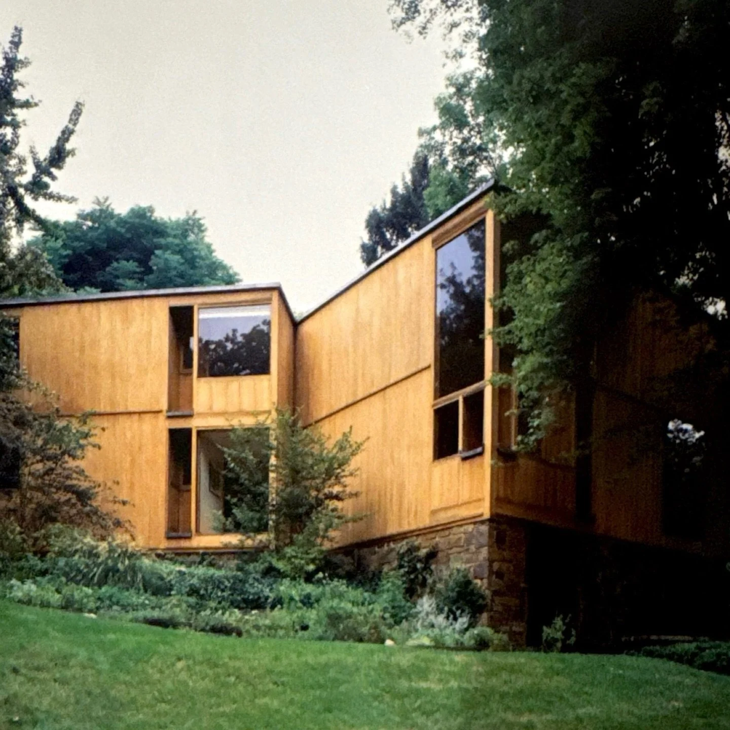 This house was designed by Louis Kahn in the early 1960s.

The Fisher House has a stone base to make up for the slope on site.
The rest of the structure is wood.
In Philadelphia at the time, wood was the cheapest and most efficient construction mater