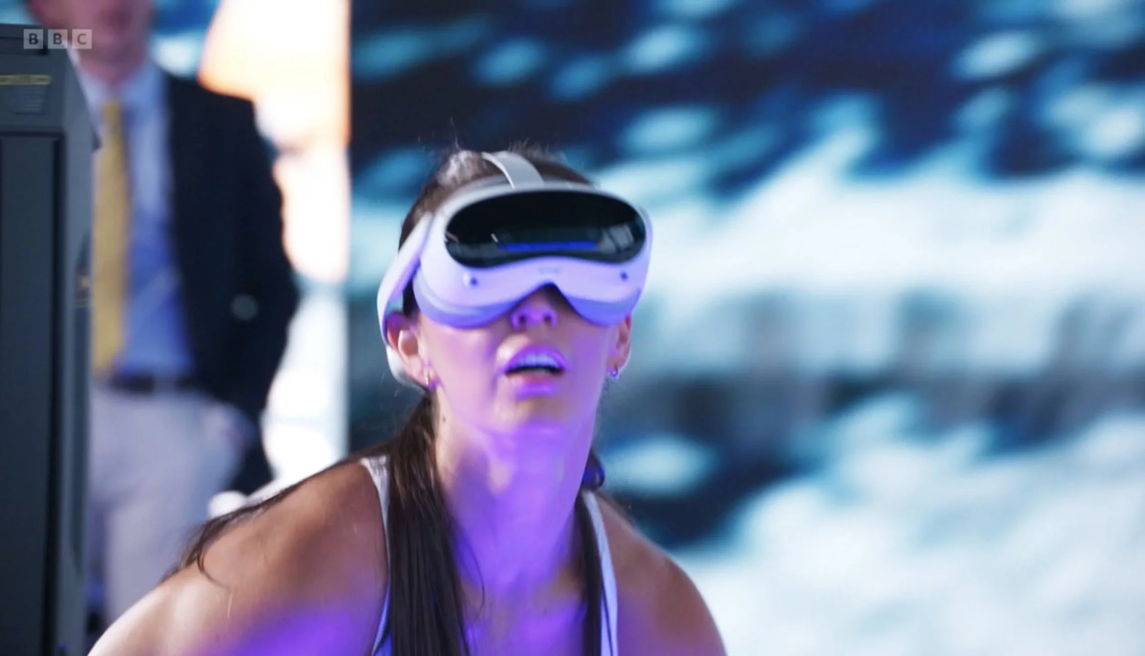 A woman wearing a virtual reality headset, Meta Quest, Pico, play a virtual fitness game made by Parachute Studios