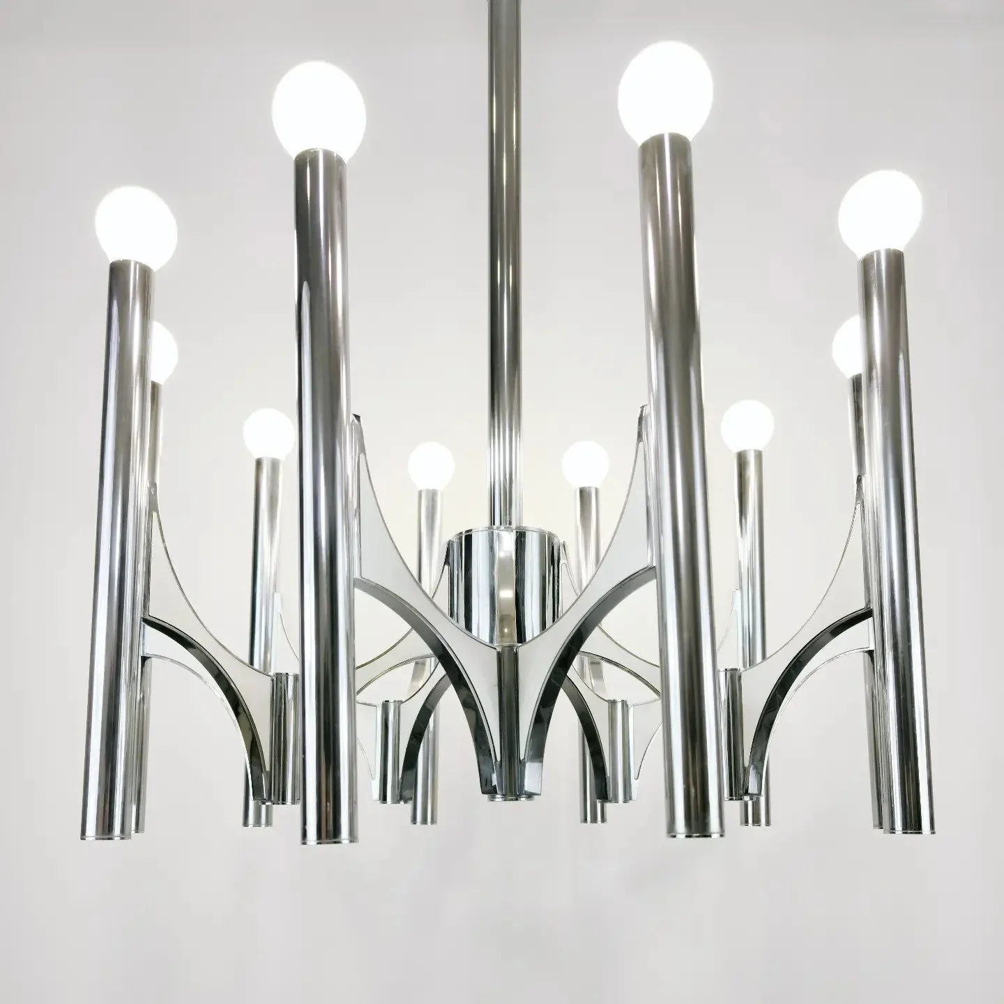 Modern chrome chandelier with multiple spherical white light bulbs hanging from curved arms.