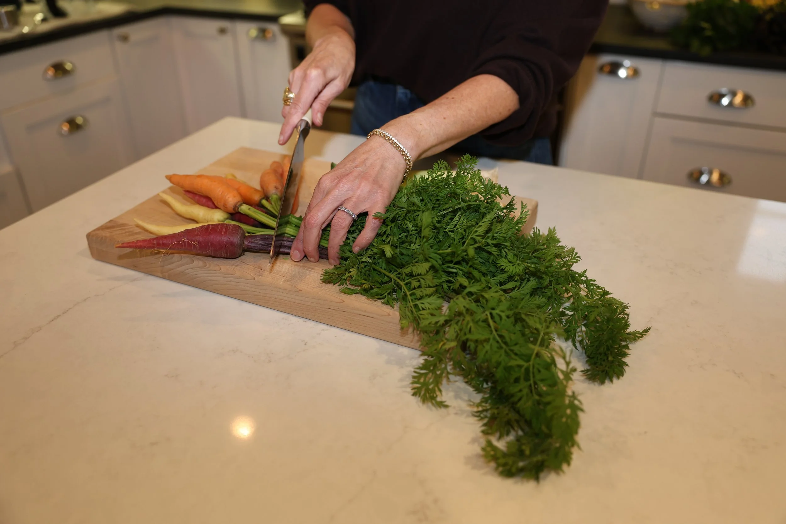 SHANNON SHIELDS CUTTING CARROTS WITH TOPS SIDE ANGLE.JPG