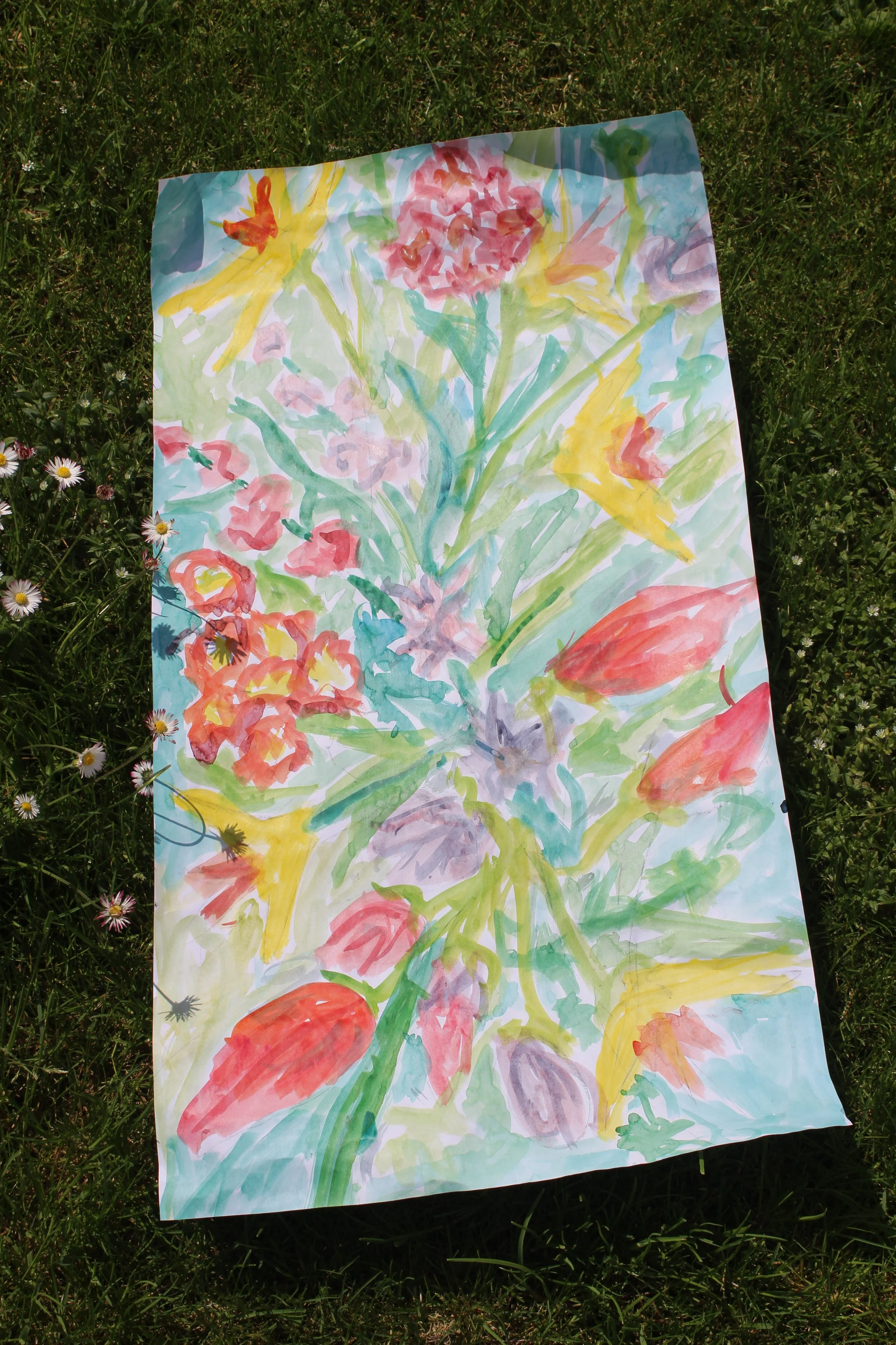 Ink painting of a bouquet of flowers laid on the grass with daisies around it