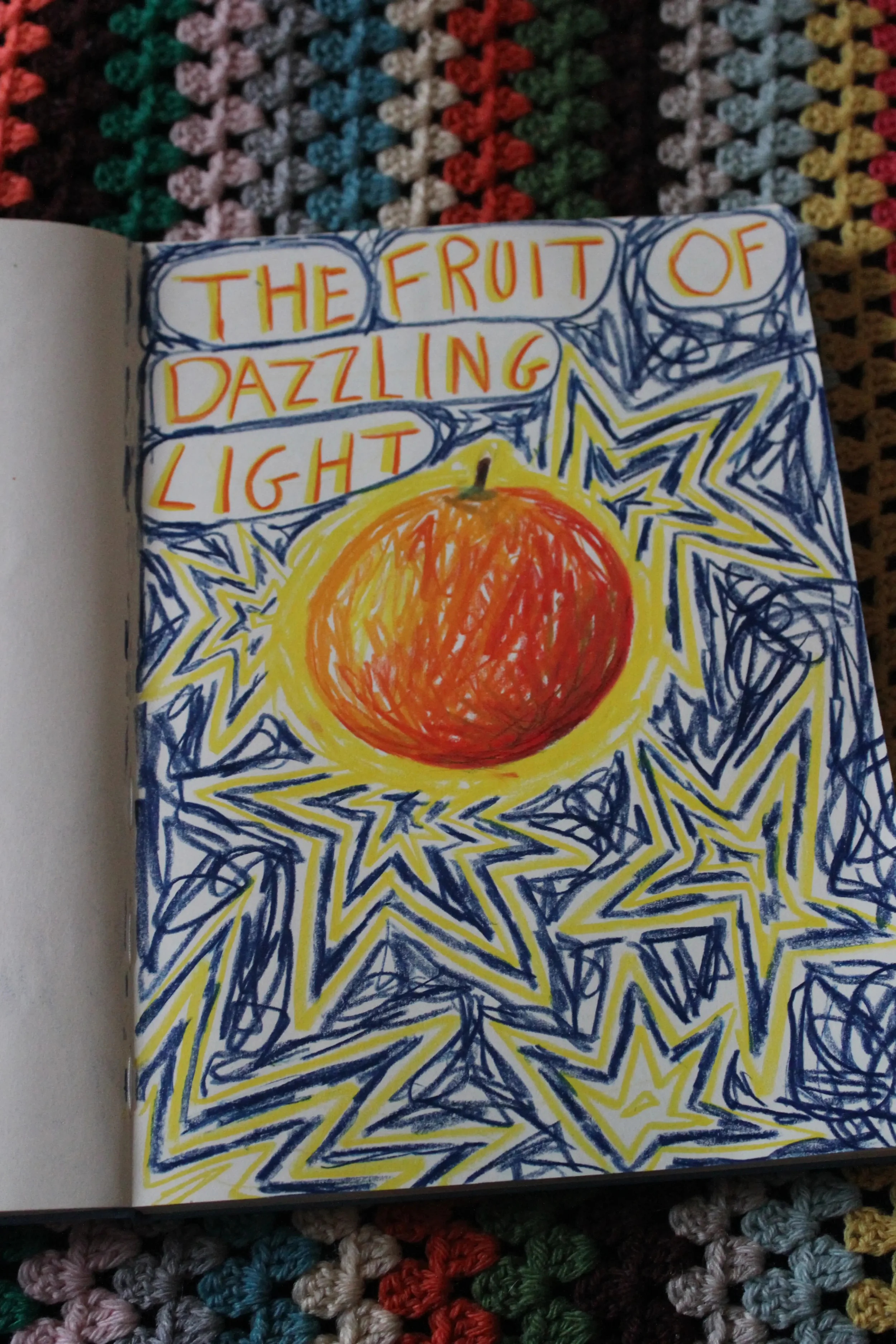 A colorful drawing with the phrase 'The fruit of dazzling light' written in orange , surrounded by stars and a large orange sun or fruit in the center.