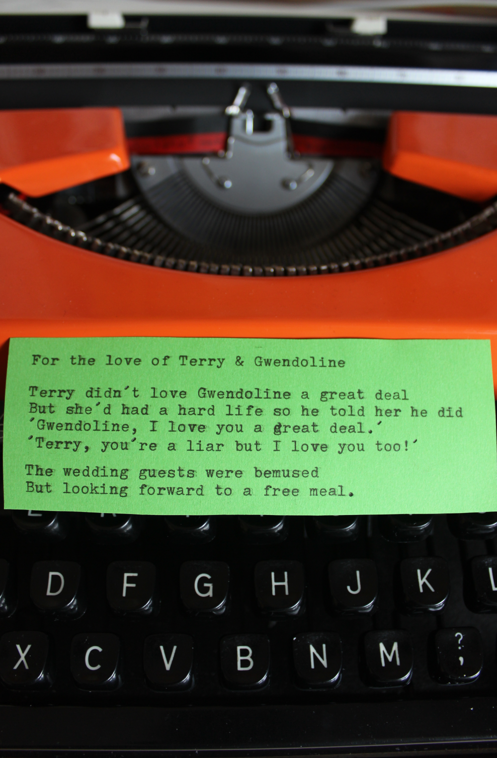 A colorful paper with a poem placed on a black typewriter.