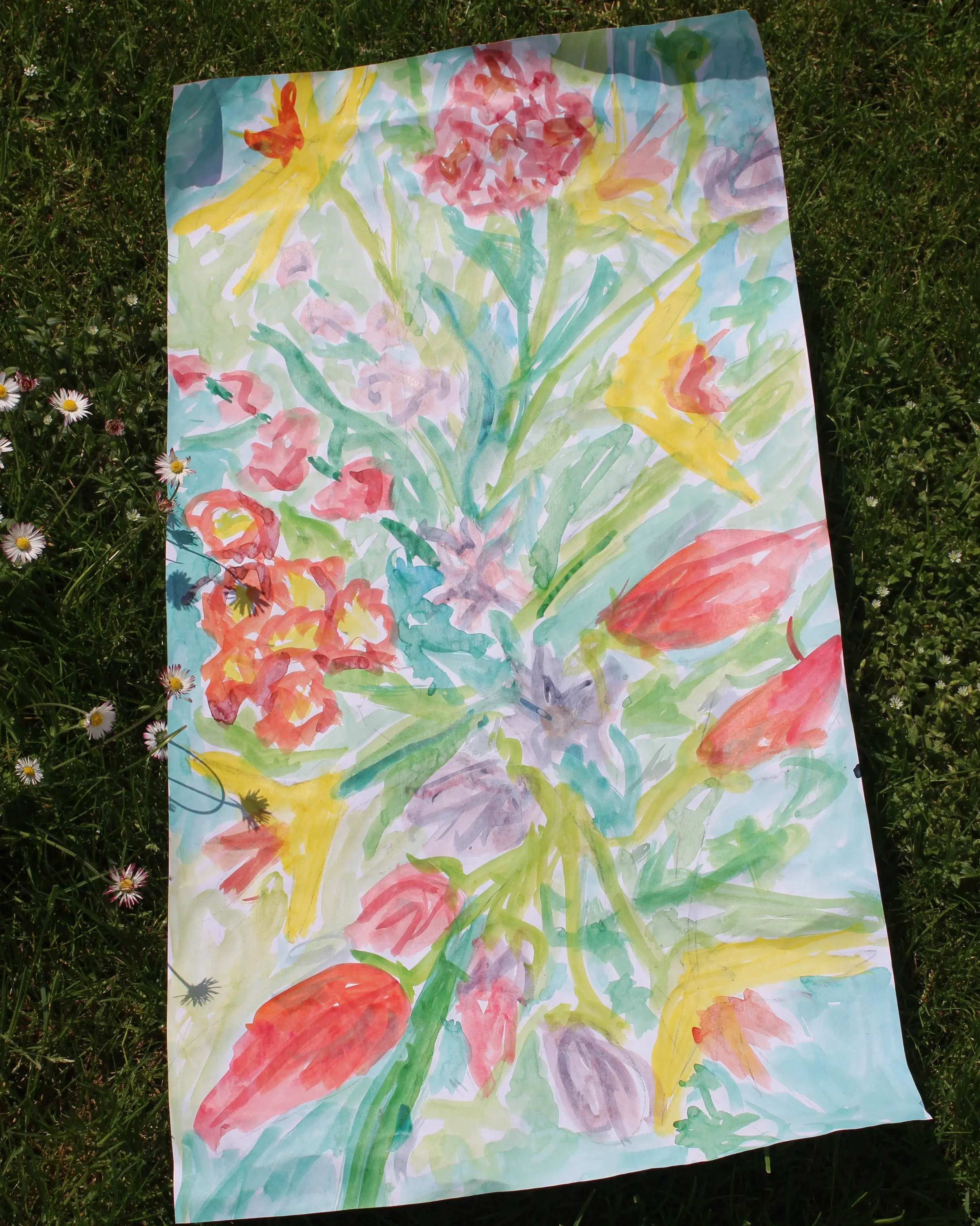 Ink painting of a bouquet of flowers laid on the grass with daisies around it.