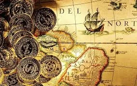 A vintage map of the West Indies with some coins placed on it.