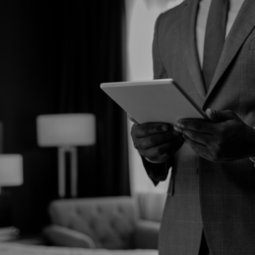 close up of executive house keeper running through a checklist on a tablet