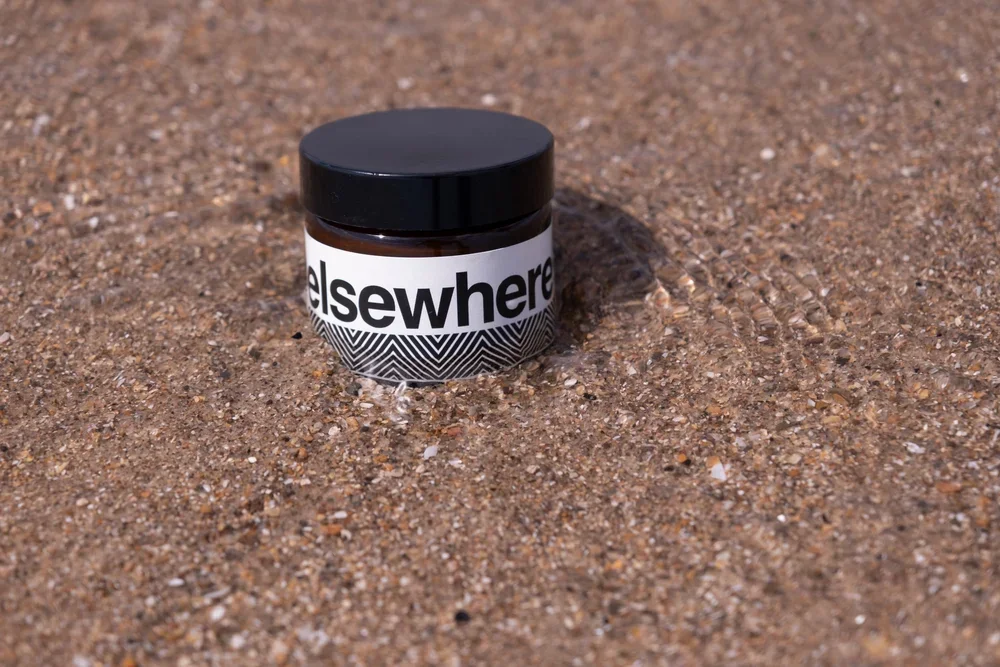 skincare product on sand
