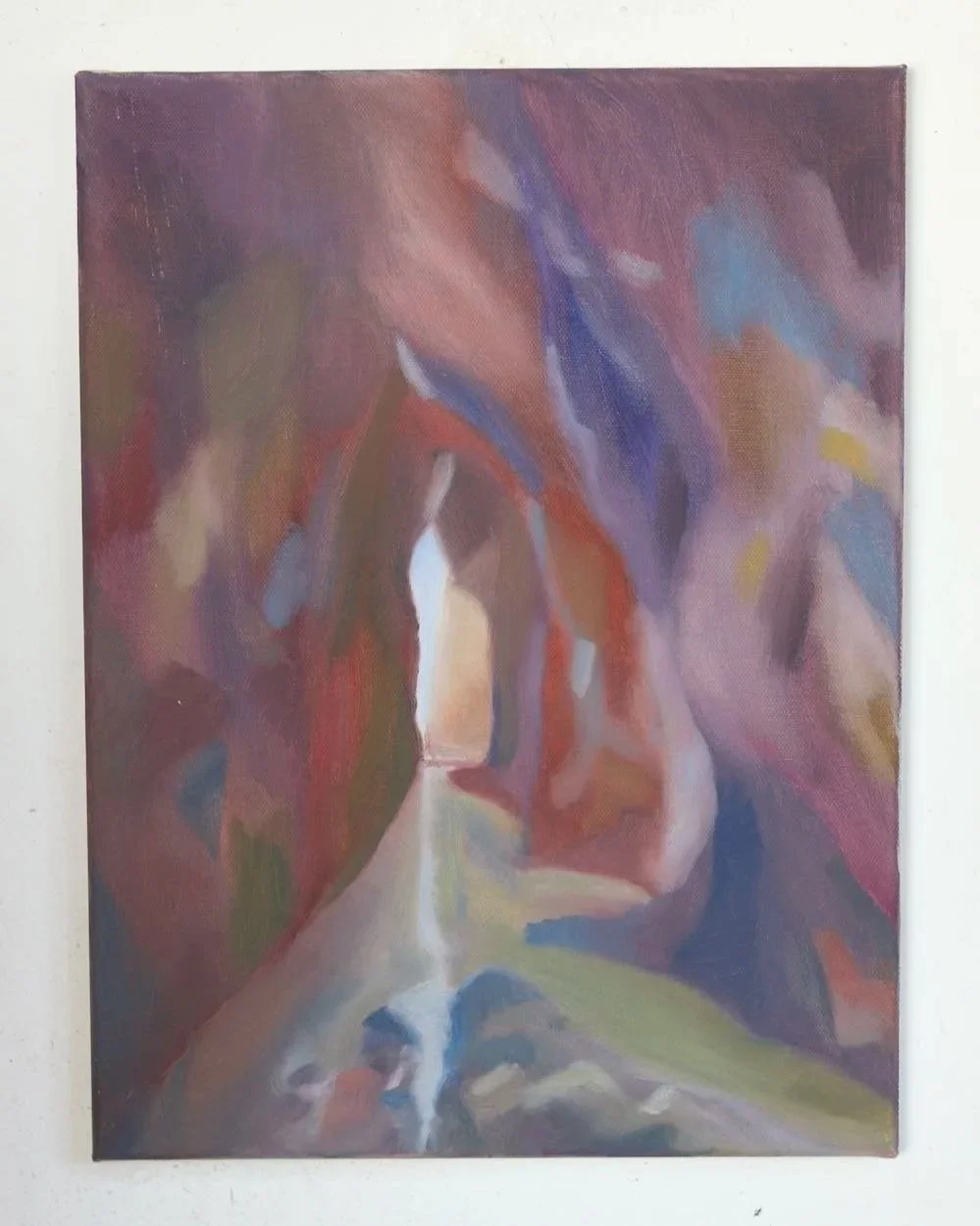 an abstract painting showing a view from inside a cave, with deep purple, blue and red