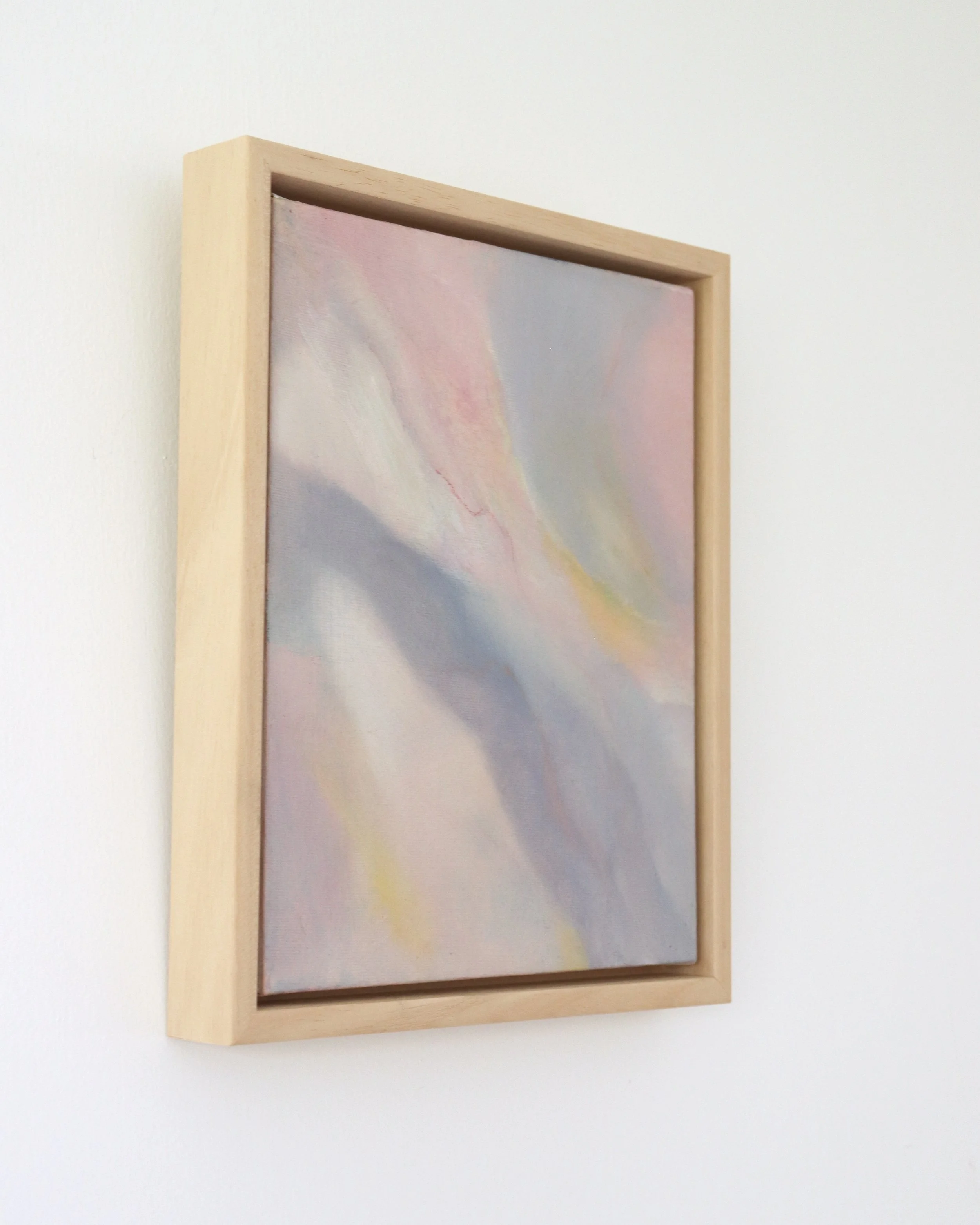 side view of small abstract painting of blue, cream and pink