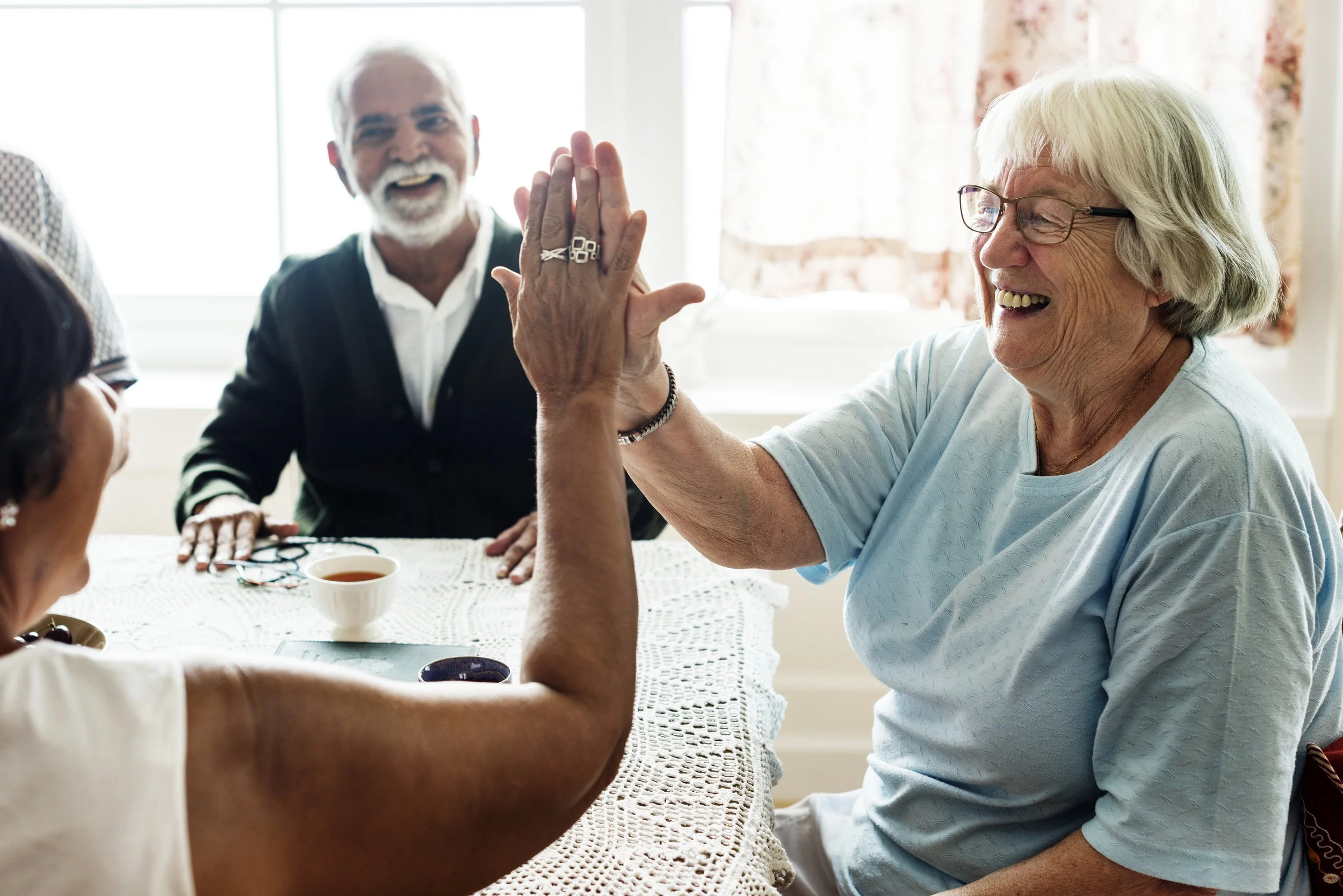 Older men and women sitting at a table