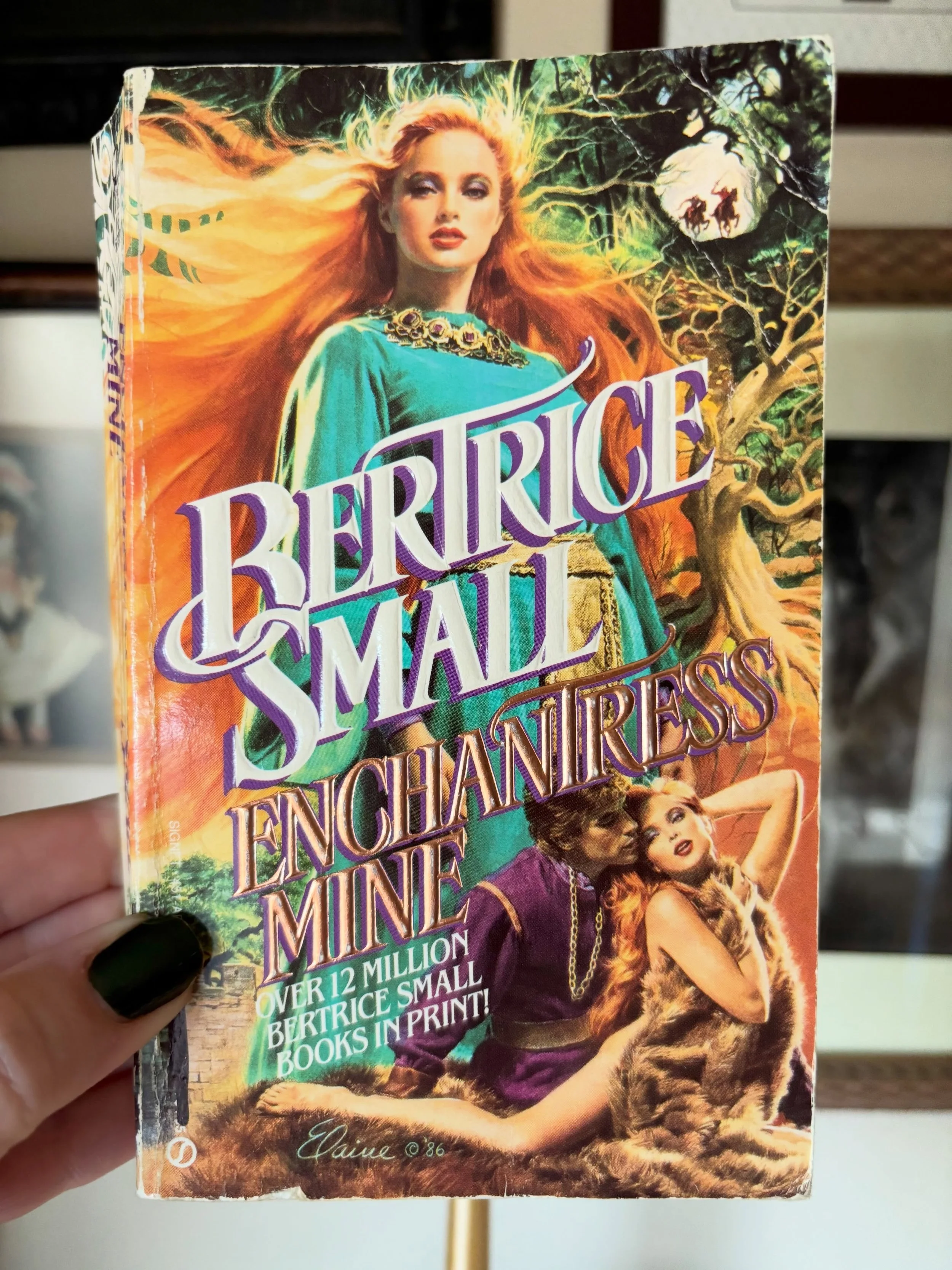 We have a wraparound for this #CoverLustFriday and a cover where the clinch is secondary to our majestic heroine posing like a flame-haired boss. I don&rsquo;t think I&rsquo;ve ever seen an artist&rsquo;s signature as prominent as this one, so Elaine