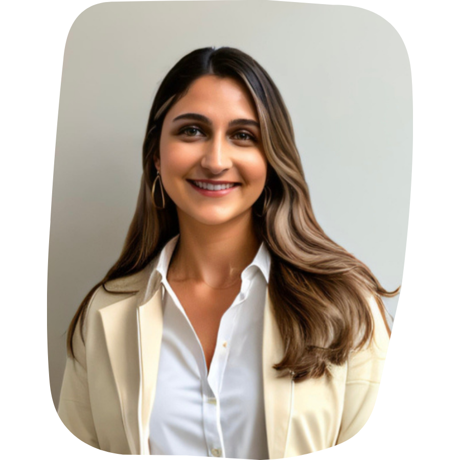 A young woman with long brown hair, wearing a white shirt and a beige blazer, smiling at the camera.