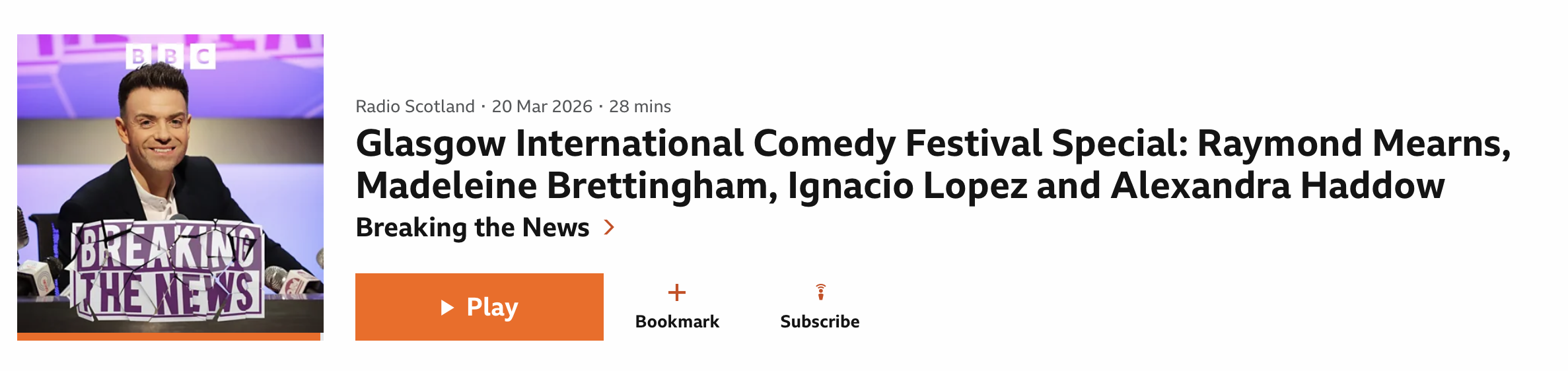 A man in a black suit and white shirt smiling at a press conference with multiple microphones in front of him, and a purple and pink background with BBC logo.