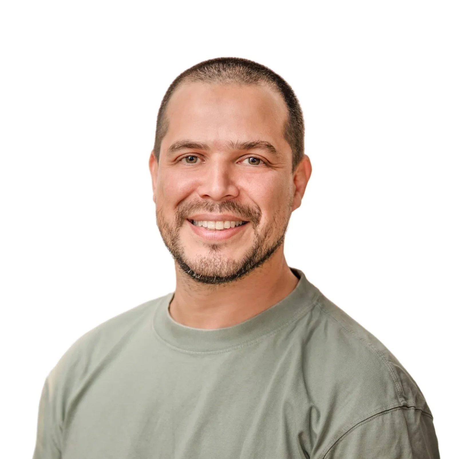 Headshot of a smiling man with short dark hair and a beard, wearing a gray t-shirt, against a plain white background.