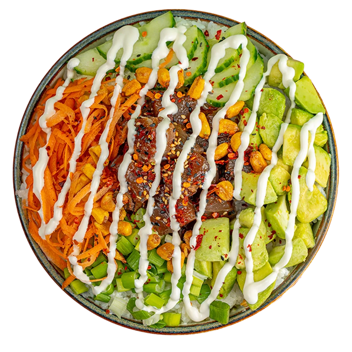 A bowl of rice topped with shredded carrots, green onions, sliced cucumbers, diced avocado, chopped peanuts, sliced meat with sauce and chili flakes, all drizzled with white sauce and sprinkled with red chili flakes.