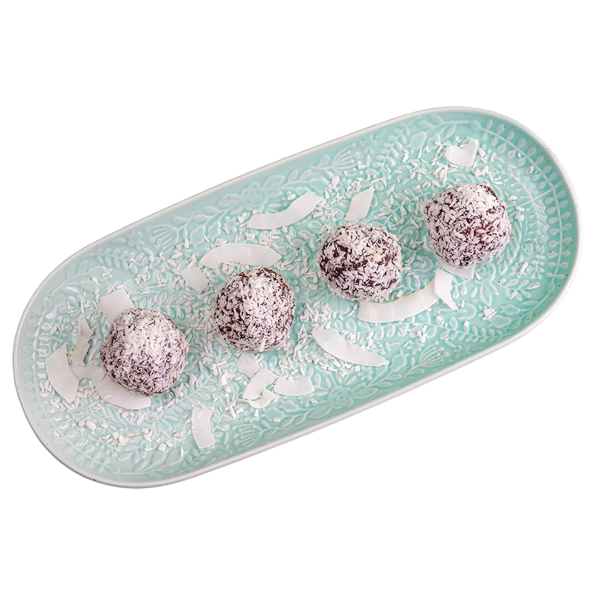 Four chocolate coconut truffles on a decorative teal plate, garnished with white coconut flakes.