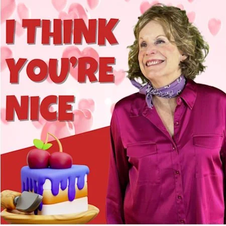 Women smiling by a cherry cake