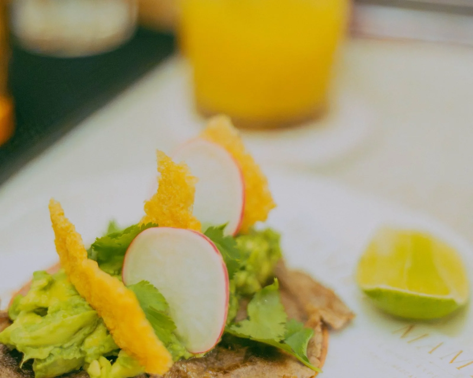 Mami's Signature taco with rib eye, guacamole and chicharrón