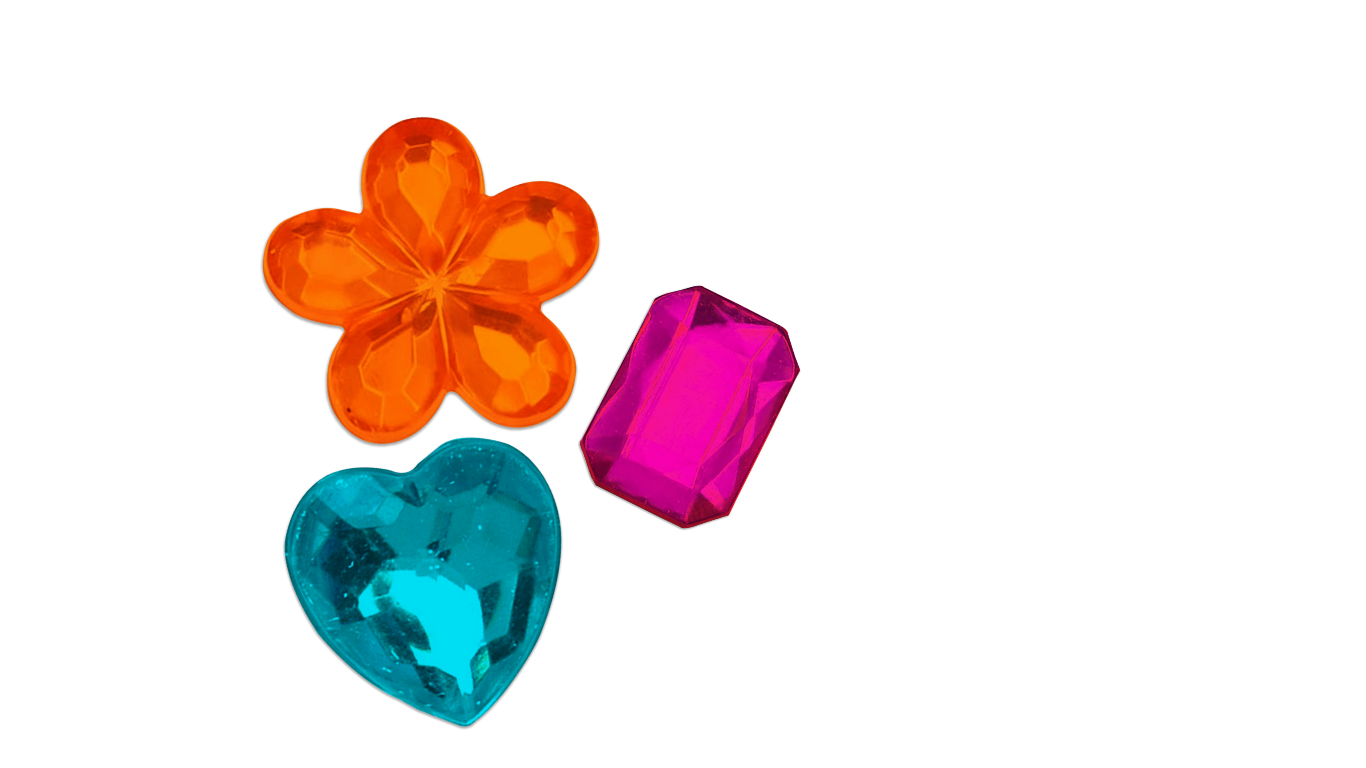 Colorful plastic gemstones including an orange flower-shaped one, a pink rectangular one, a blue heart-shaped one, and a blue oval one on a black background.