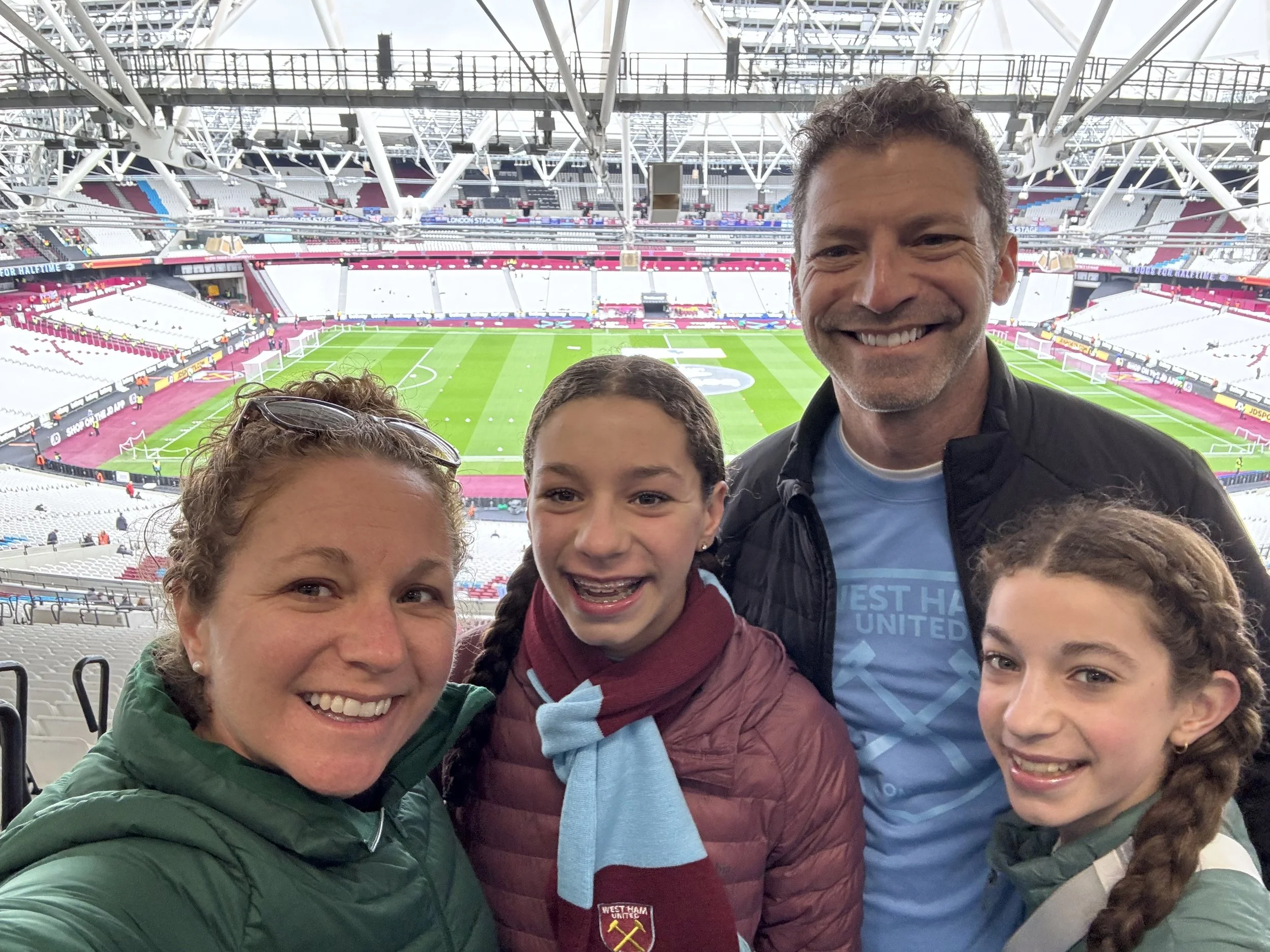 Family selfie wearing West Ham scarves at London Stadium