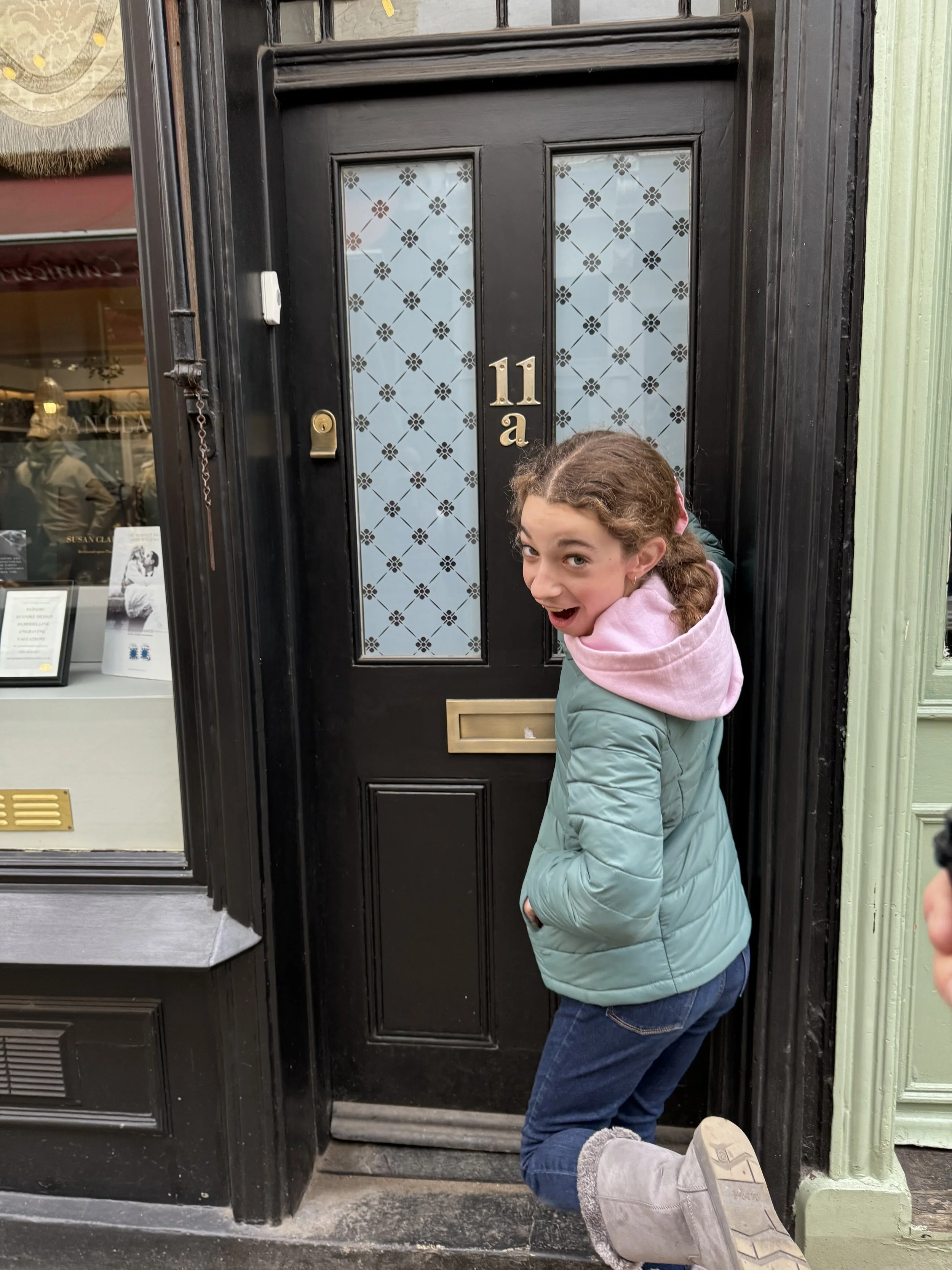 Girl posing at Ted Lasso filming location door in Richmond