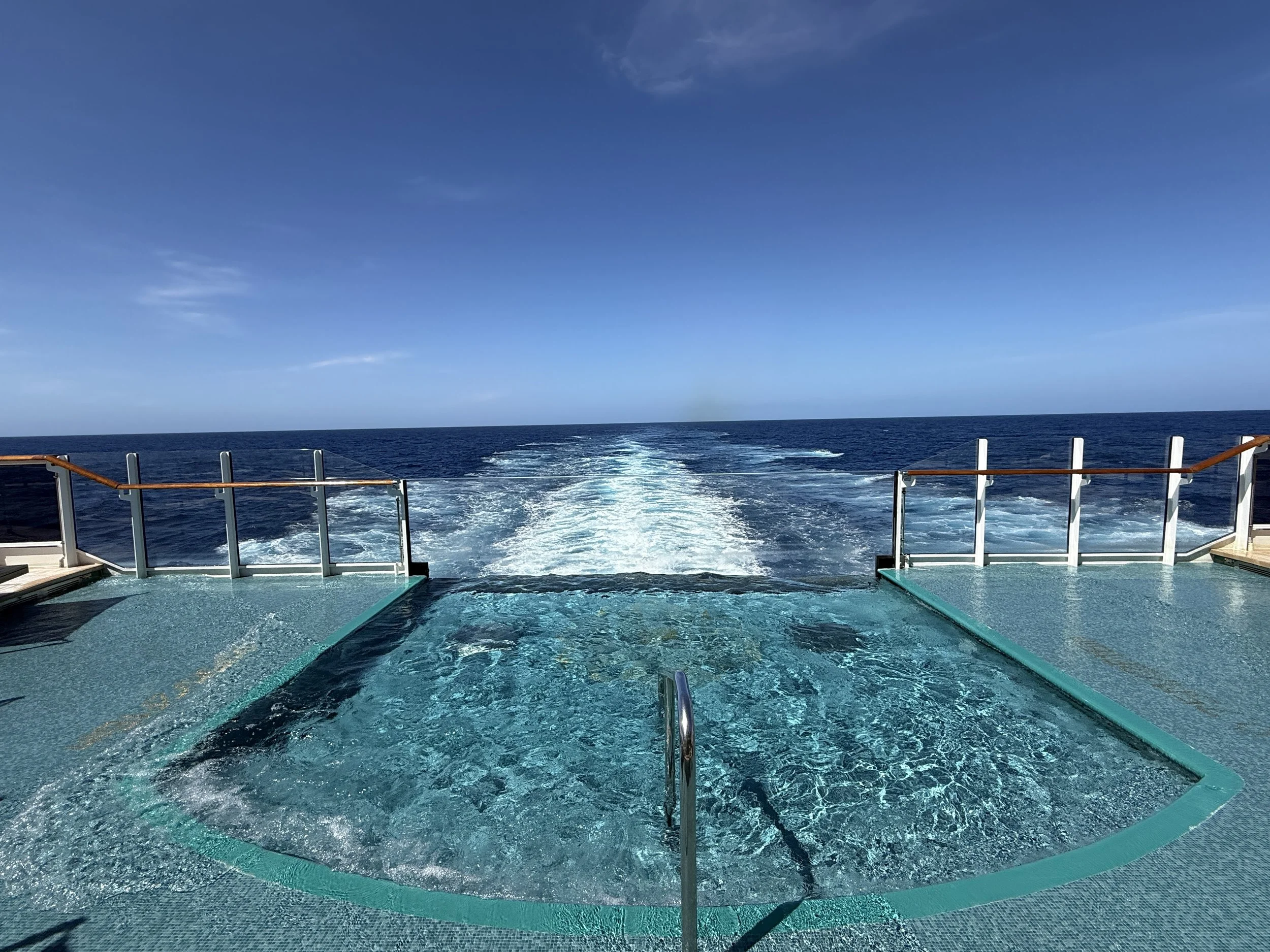 Explora Journeys aft infinity pool overlooking the ship's wake and open ocean