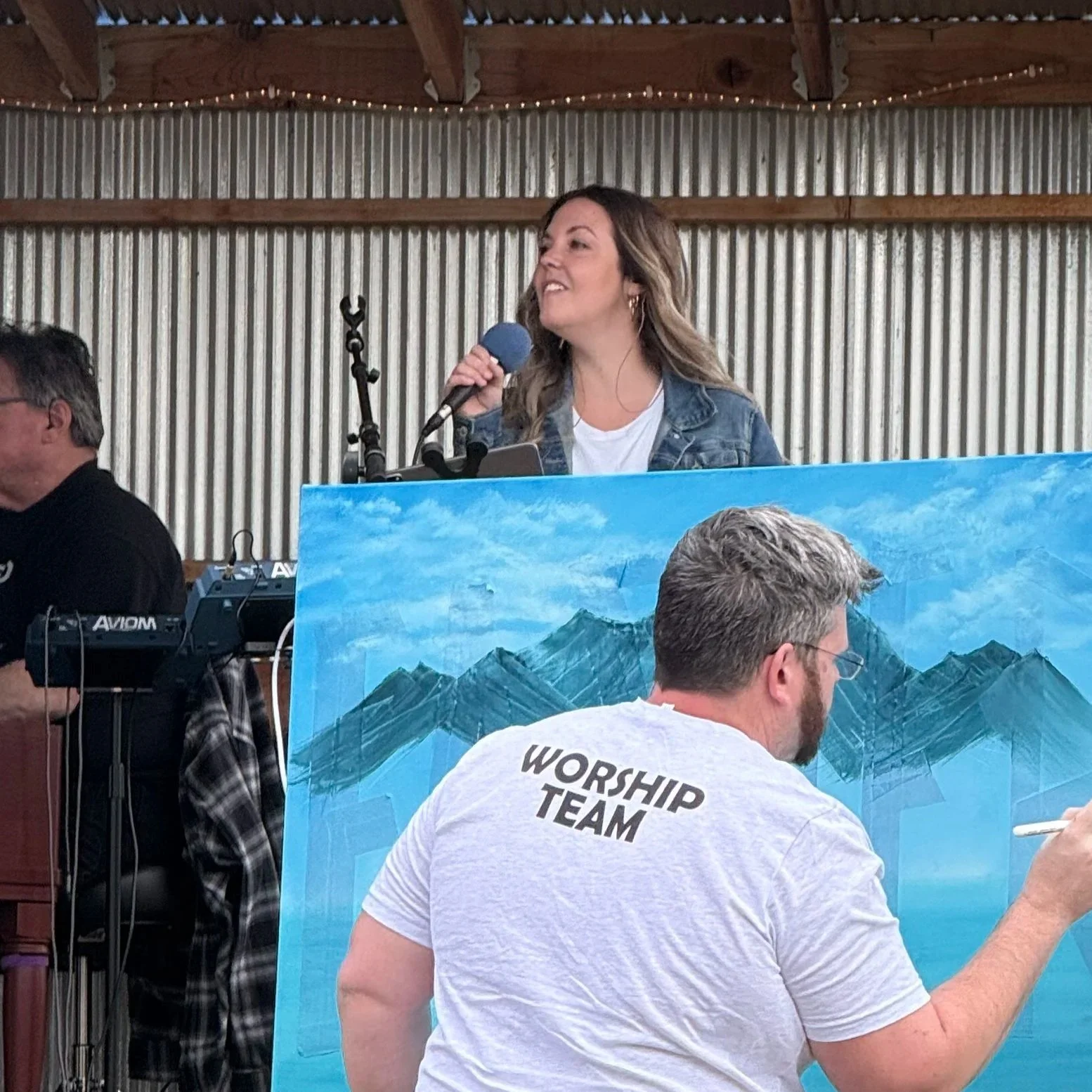 Brittany Brown leading worship and collaborating with musicians during a live church music event.